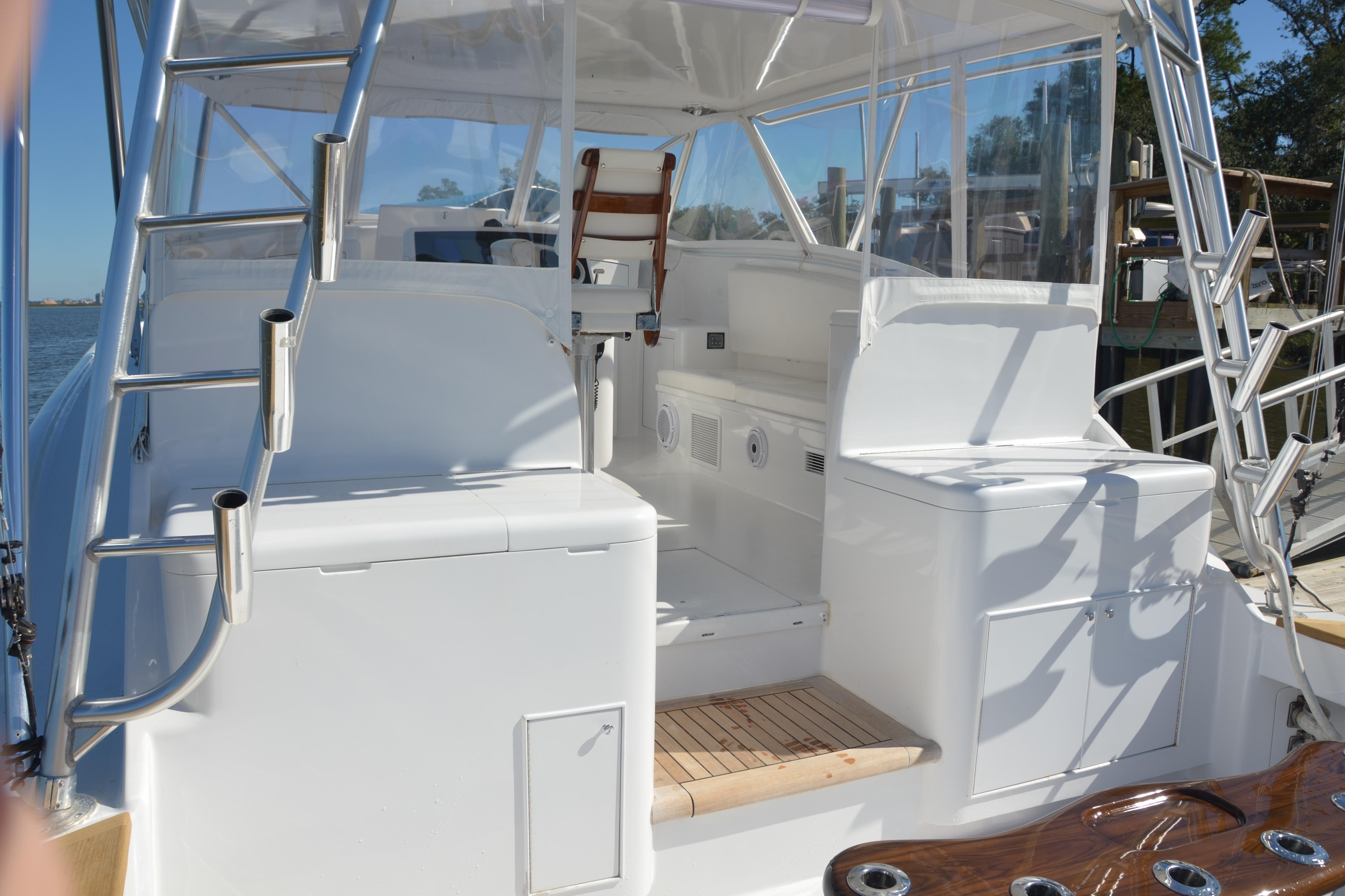 2006 Custom Carolina Heritage Express boat interior with seating and ladder, docked by the water.
