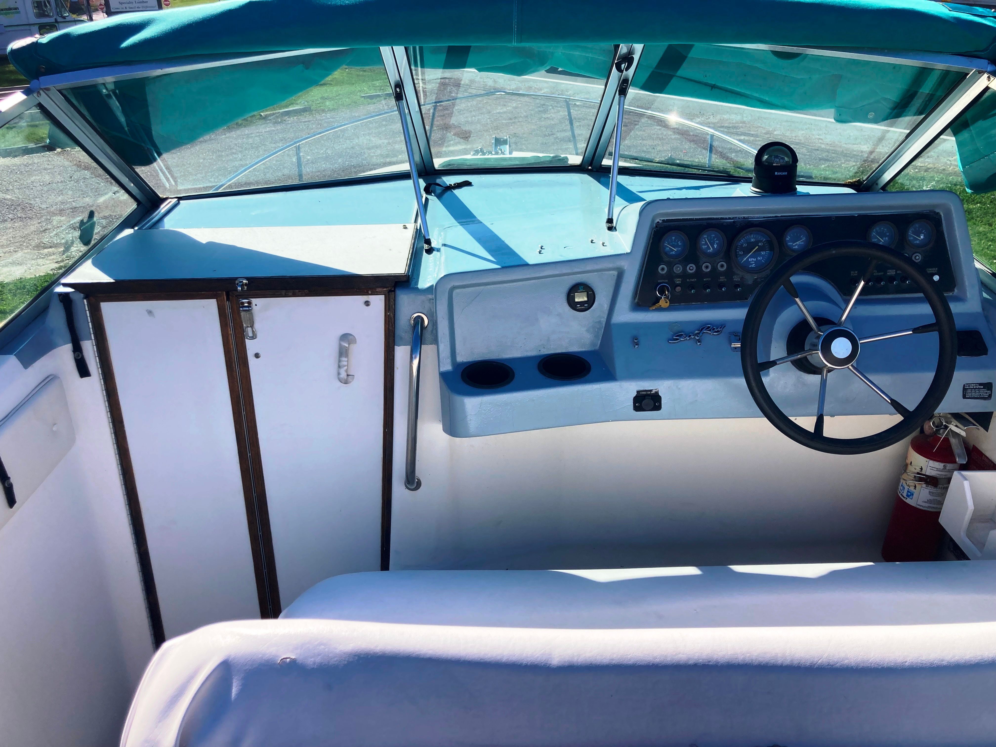 The cockpit of a 1991 Sea Ray 220 Sundancer with steering wheel and instrument panel.