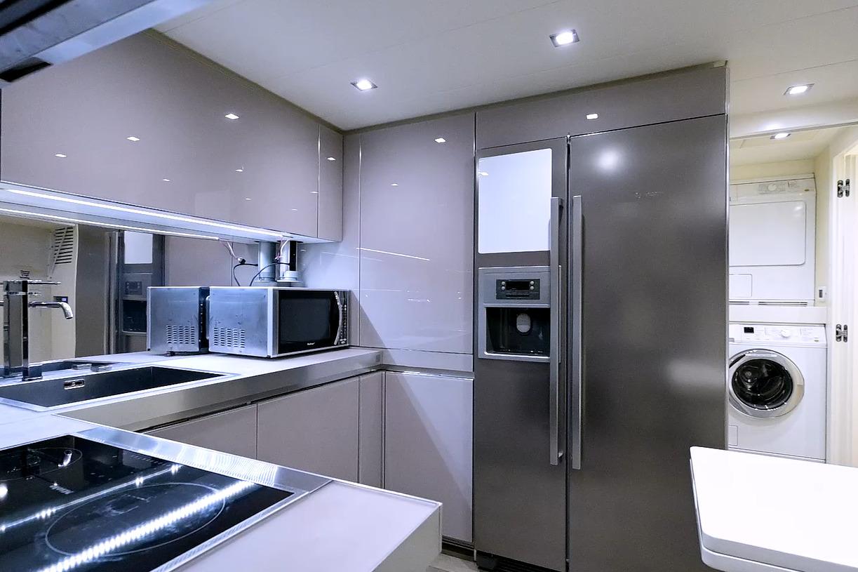Modern kitchen interior on 2015 Pershing 92 yacht with sleek appliances and cabinetry.