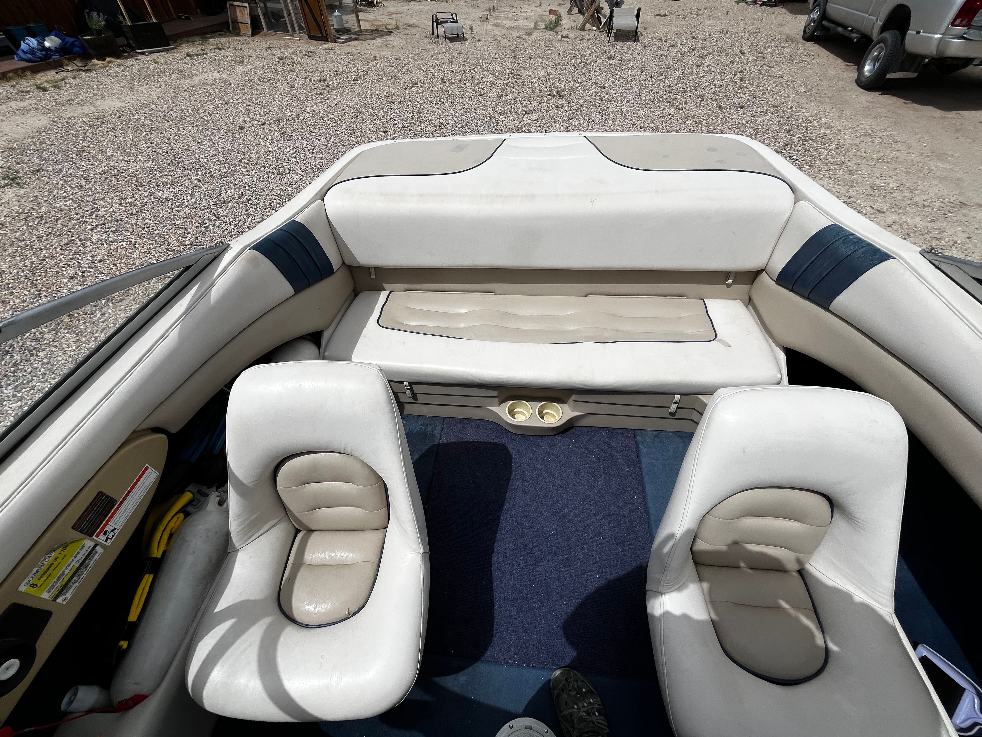 Interior view of a 1998 Glastron SE199 with white seats and blue carpeting.