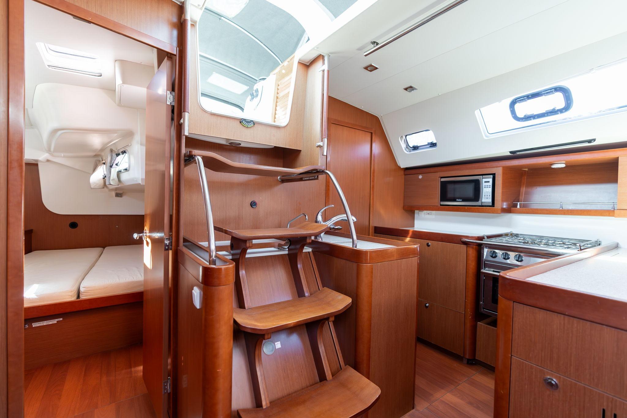 2013 Beneteau Oceanis 50 yacht interior with kitchen, stairs, and cabin view.