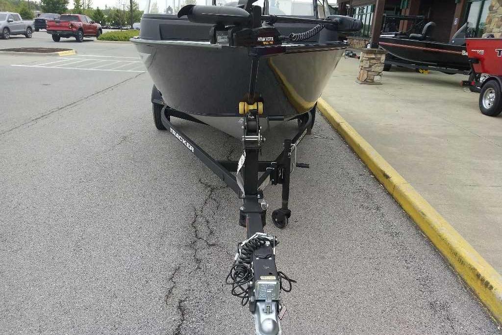 2026 Tracker Pro Guide V-16 WT boat on trailer in parking lot.