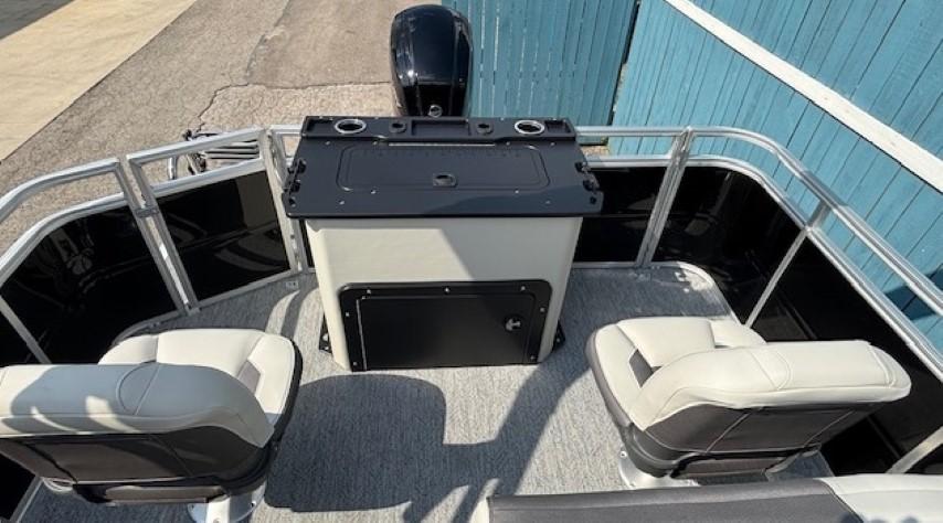 2026 Sun Tracker Fishin' Barge 20 DLX interior with seating and control panel.
