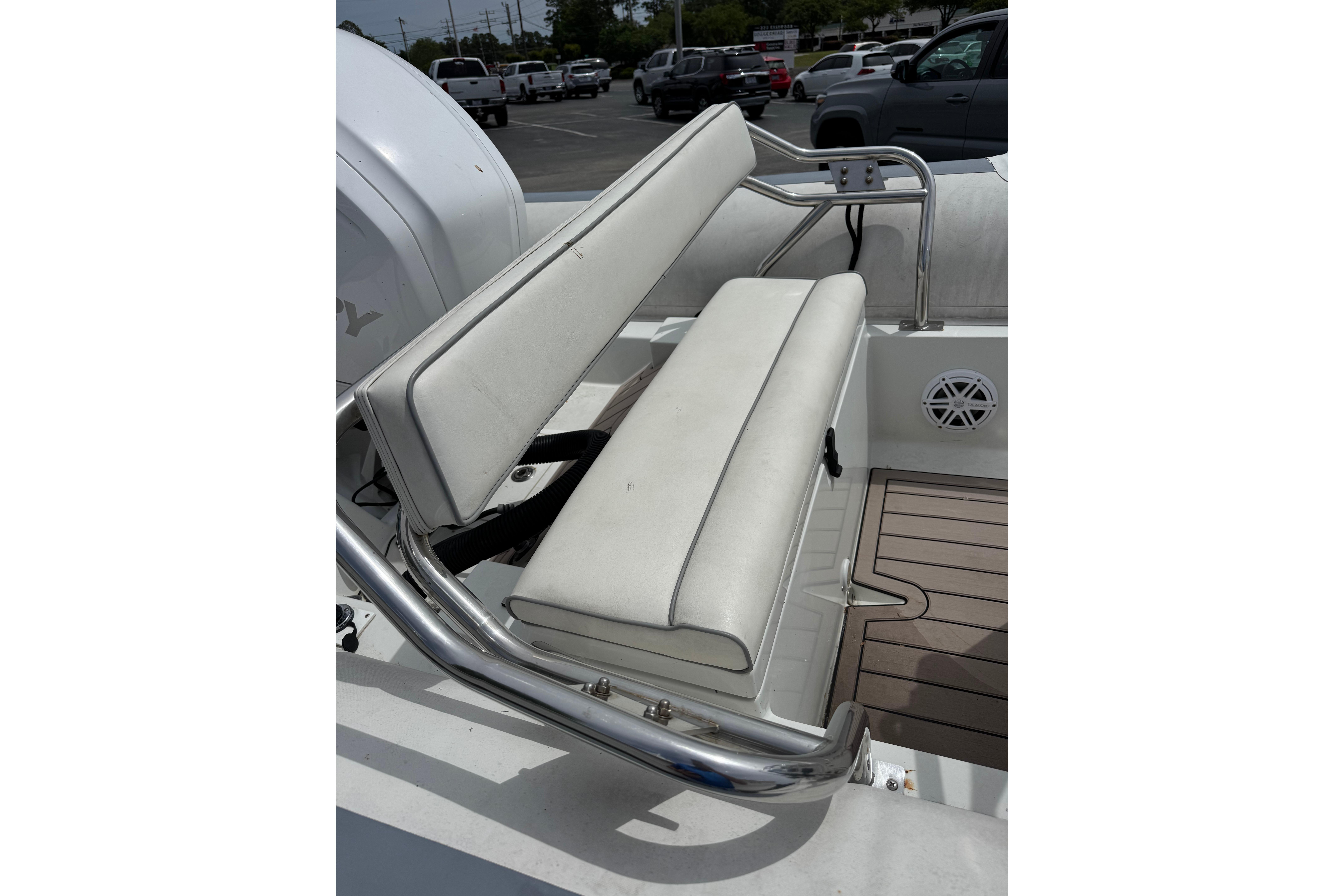 White seating on a 2002 Novurania 17 boat, featuring stainless steel railings.