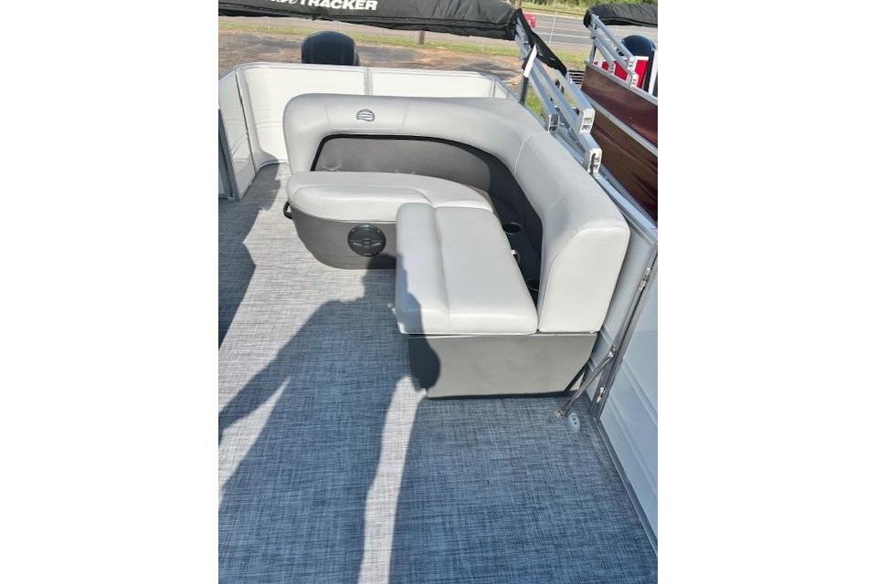 2026 Sun Tracker Party Barge 18 DLX interior with gray seating and carpeted flooring.
