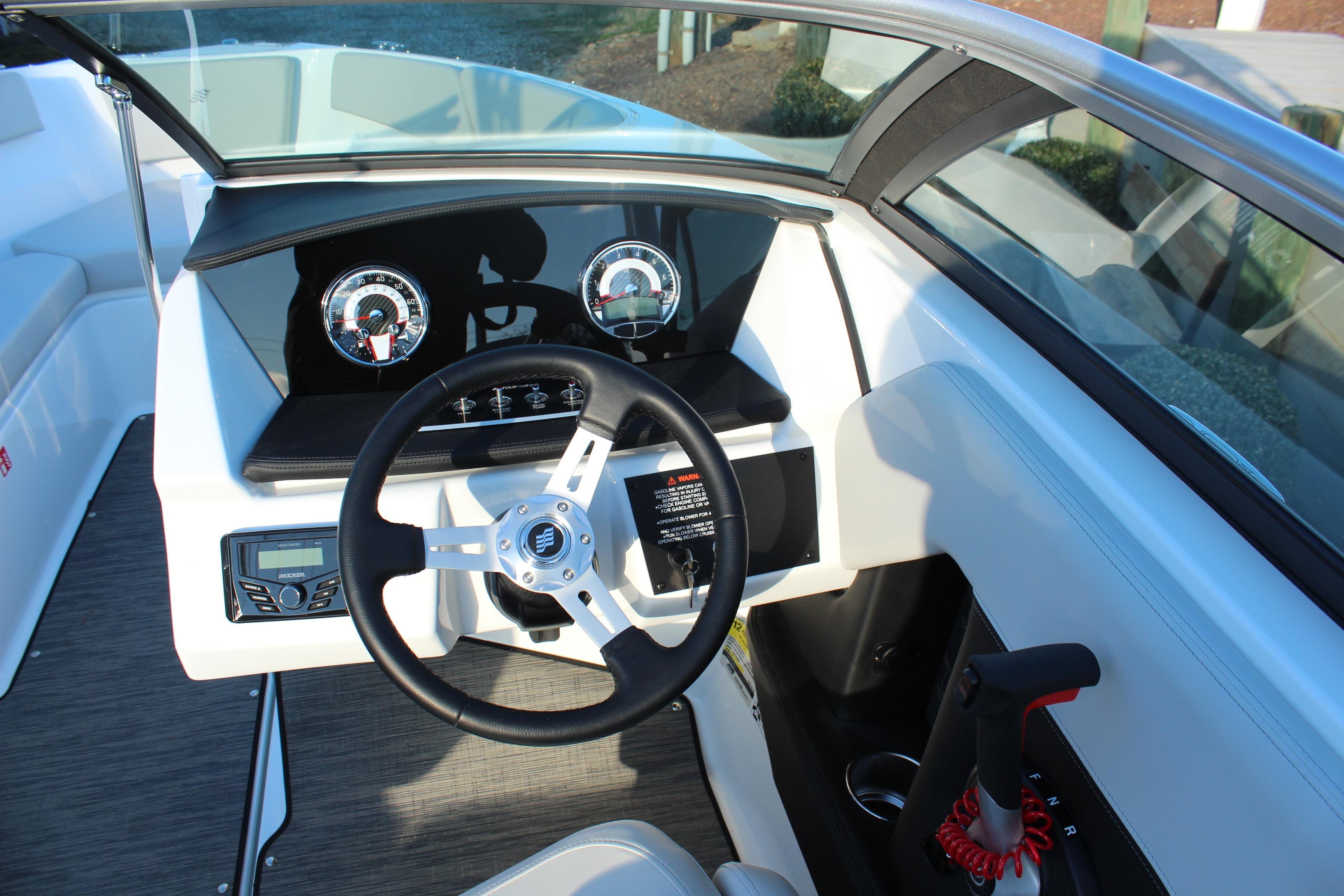 2026 Four Winns H2 Freedom boat dashboard with steering wheel and control panel.