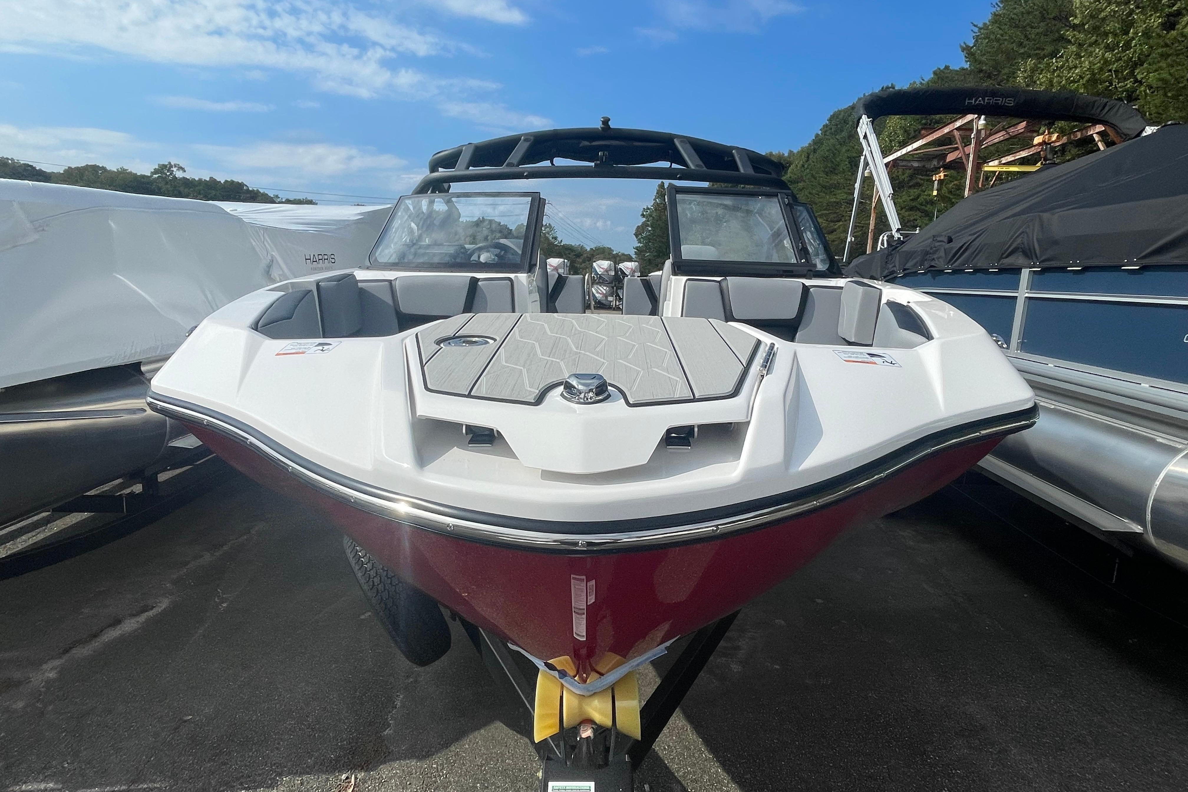 2026 Yamaha Boats 222XD, sleek design, docked outdoors, clear sky background.
