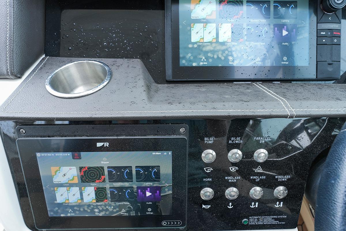 Control panel of a 2018 Sea Ray SLX 350 boat with touchscreen displays and switches.