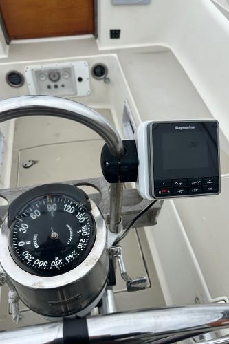 Cockpit of 1983 O'Day 39 sailboat with compass and Raymarine display.