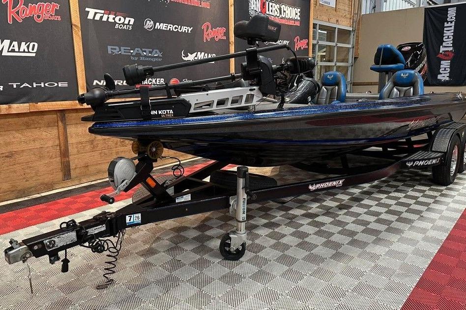 2017 Phoenix 919 ProXP boat on trailer in showroom with promotional banners.