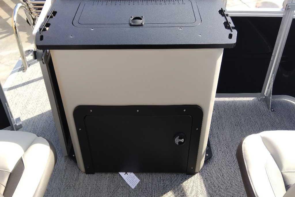 2026 Sun Tracker Fishin' Barge 22 DLX interior with storage compartment and seating.