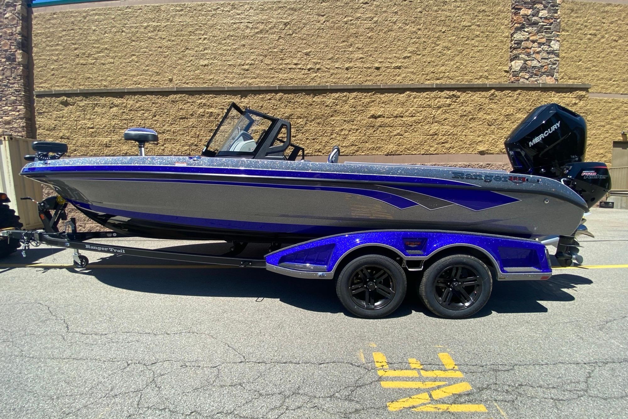 2026 Ranger 622FS Pro boat with Mercury engine, parked on a trailer in sunlight.