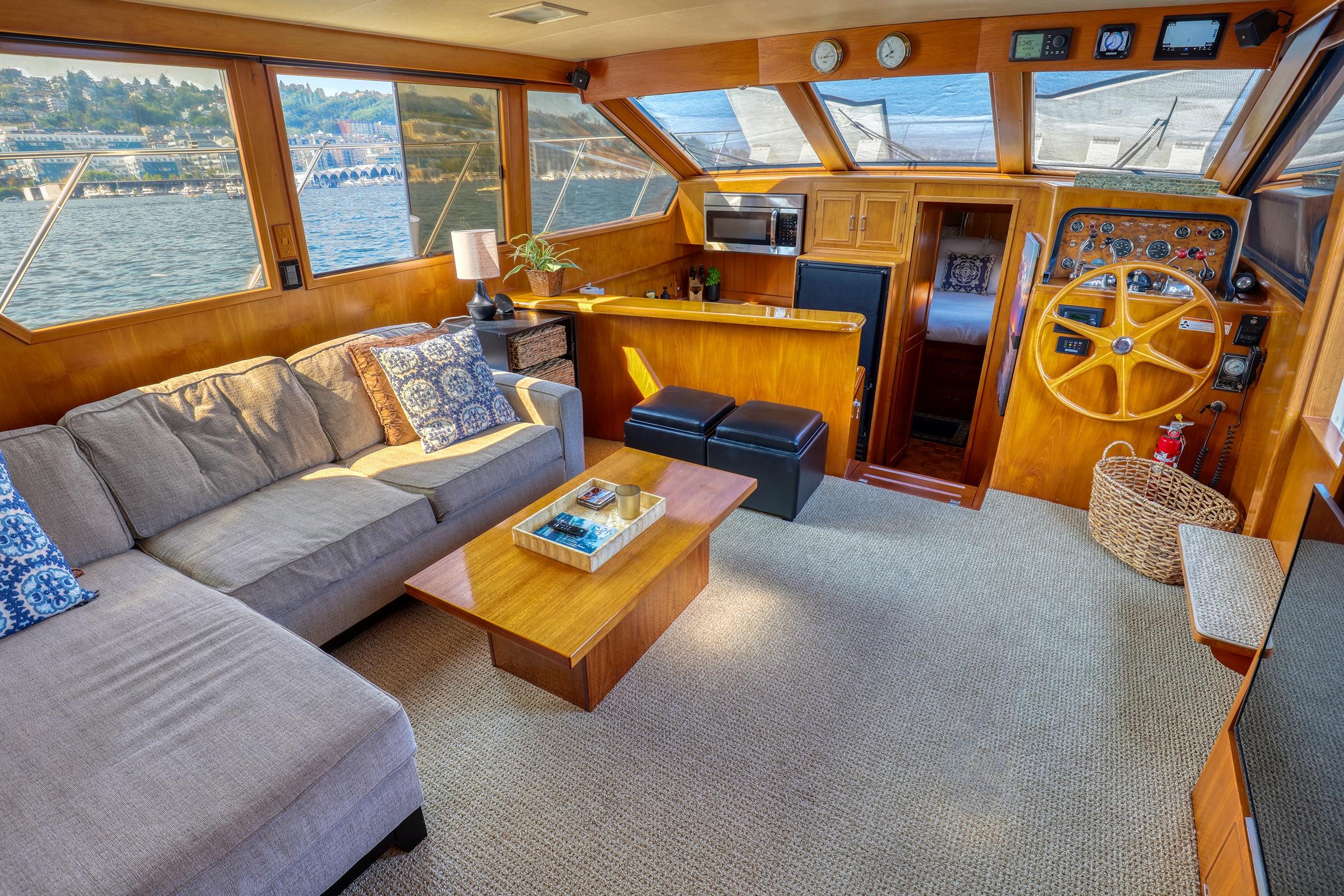 Luxurious interior of 1987 Ocean Alexander 480 Sport Sedan yacht with cozy seating and helm.