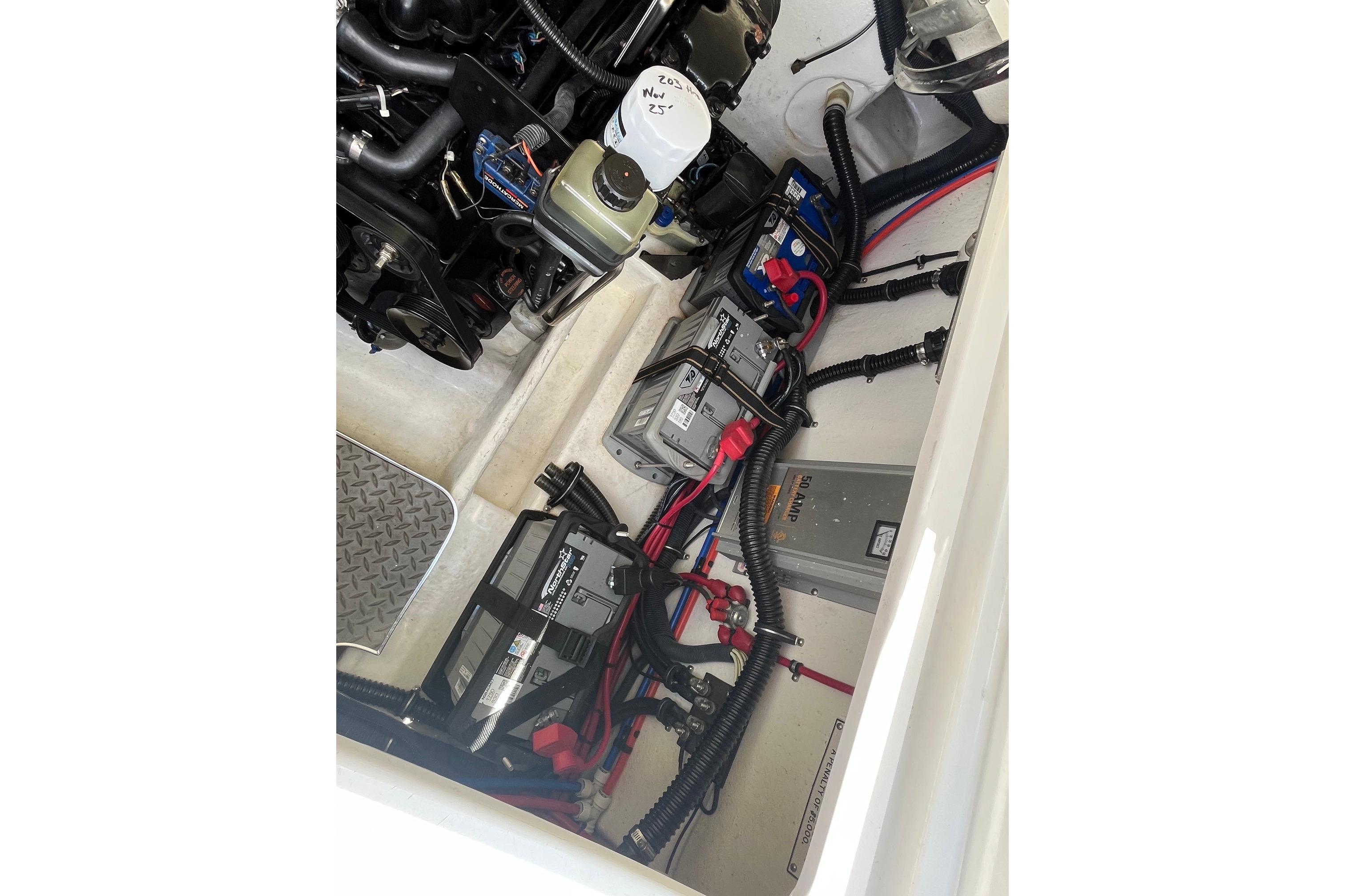 Engine compartment of a 2002 Formula 330 Sun Sport boat, showing batteries and wiring.