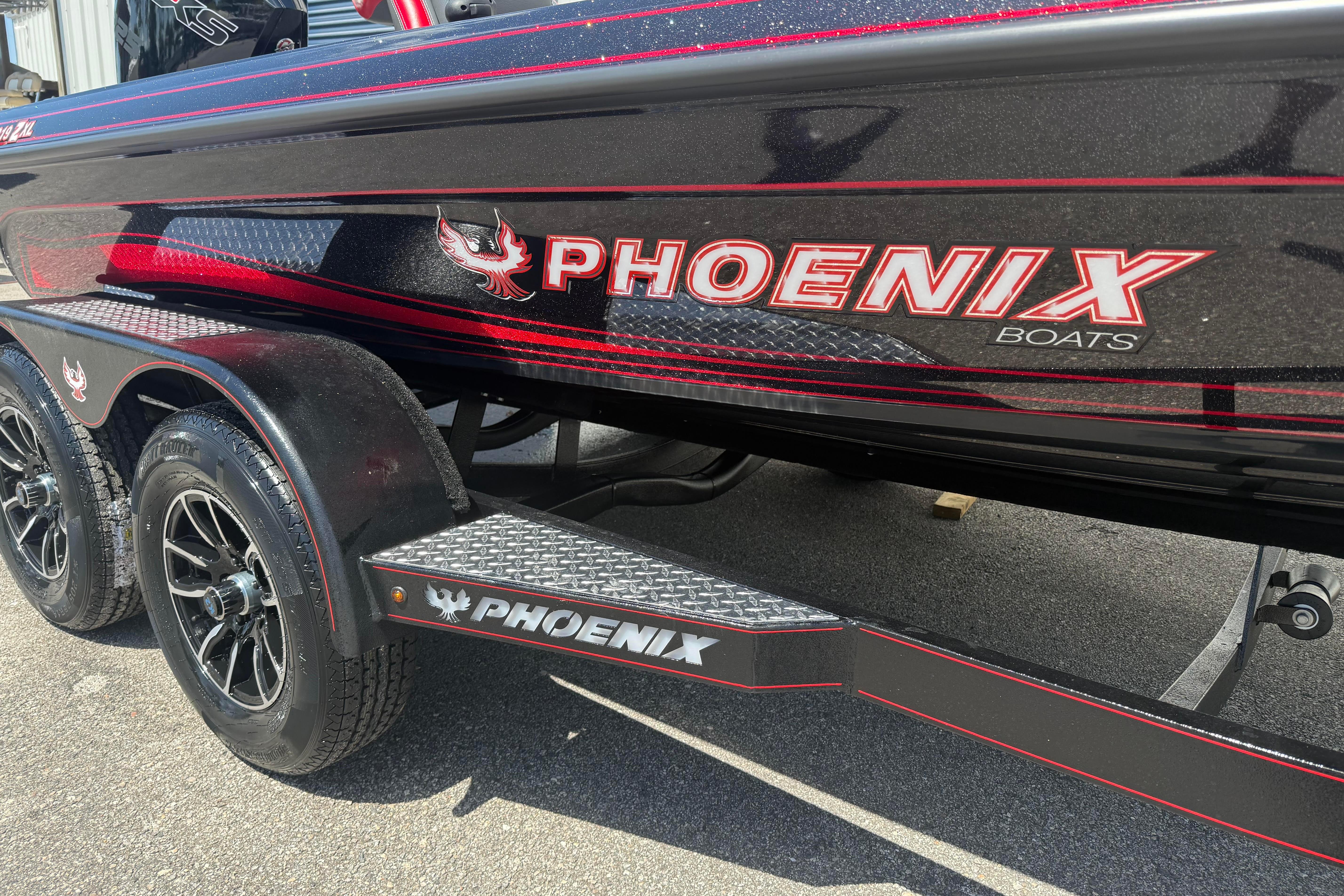 2027 Phoenix 919 ZXL boat with sleek black and red design on trailer.
