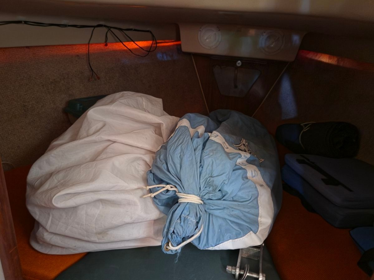 Interior of a 1979 O'Day Sloop with sails and gear.