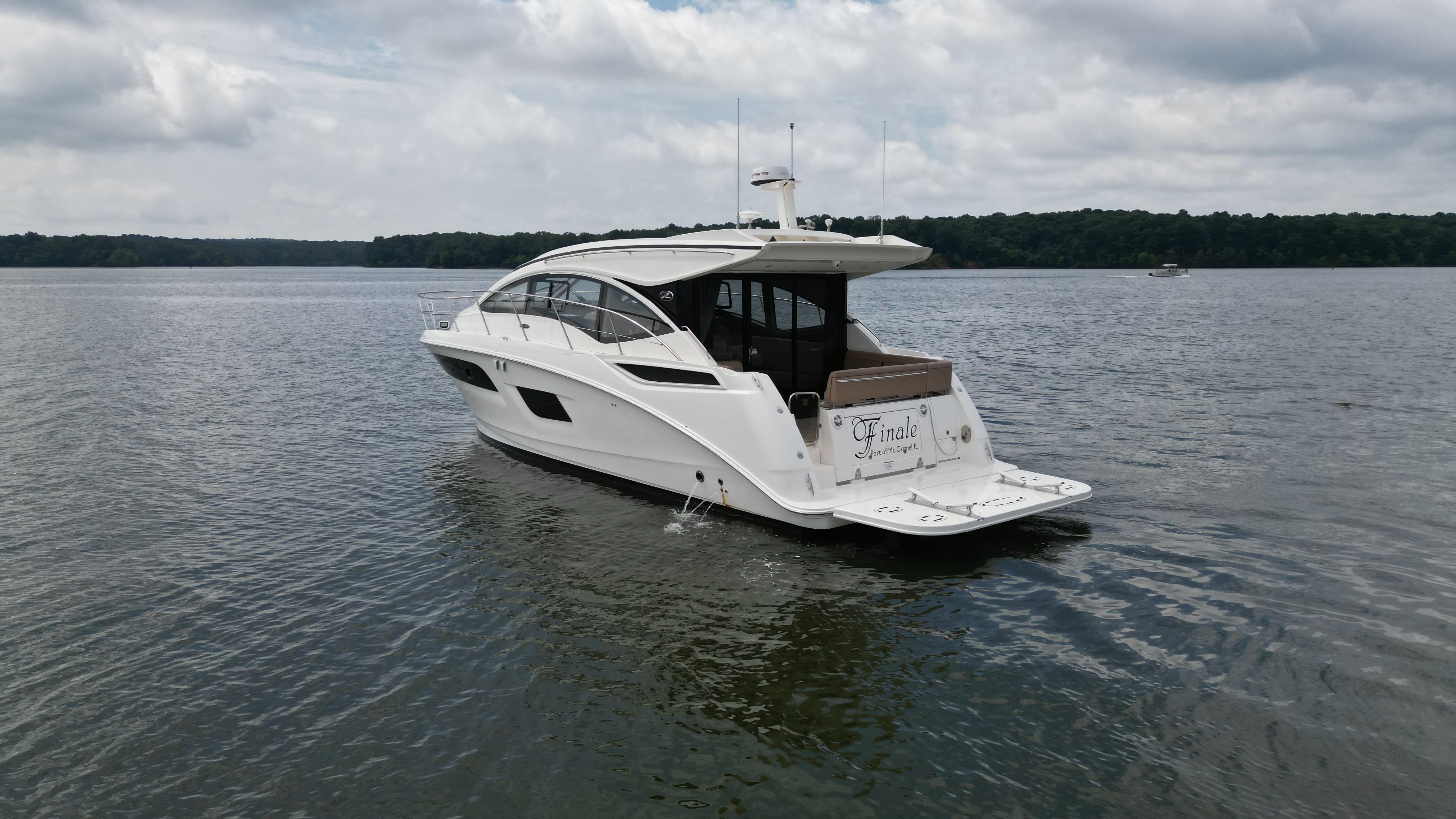 2017 Sea Ray Sundancer 400 yacht cruising on a calm lake under cloudy skies.