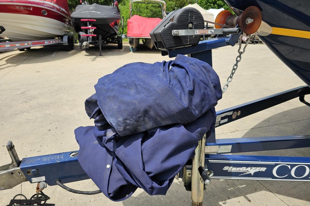 Boat trailer with blue cover, Cobalt 232 WSS, 2010 model, parked outdoors.