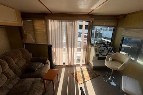 Interior of a 1995 Myacht 40X13 houseboat with cozy seating and helm station.