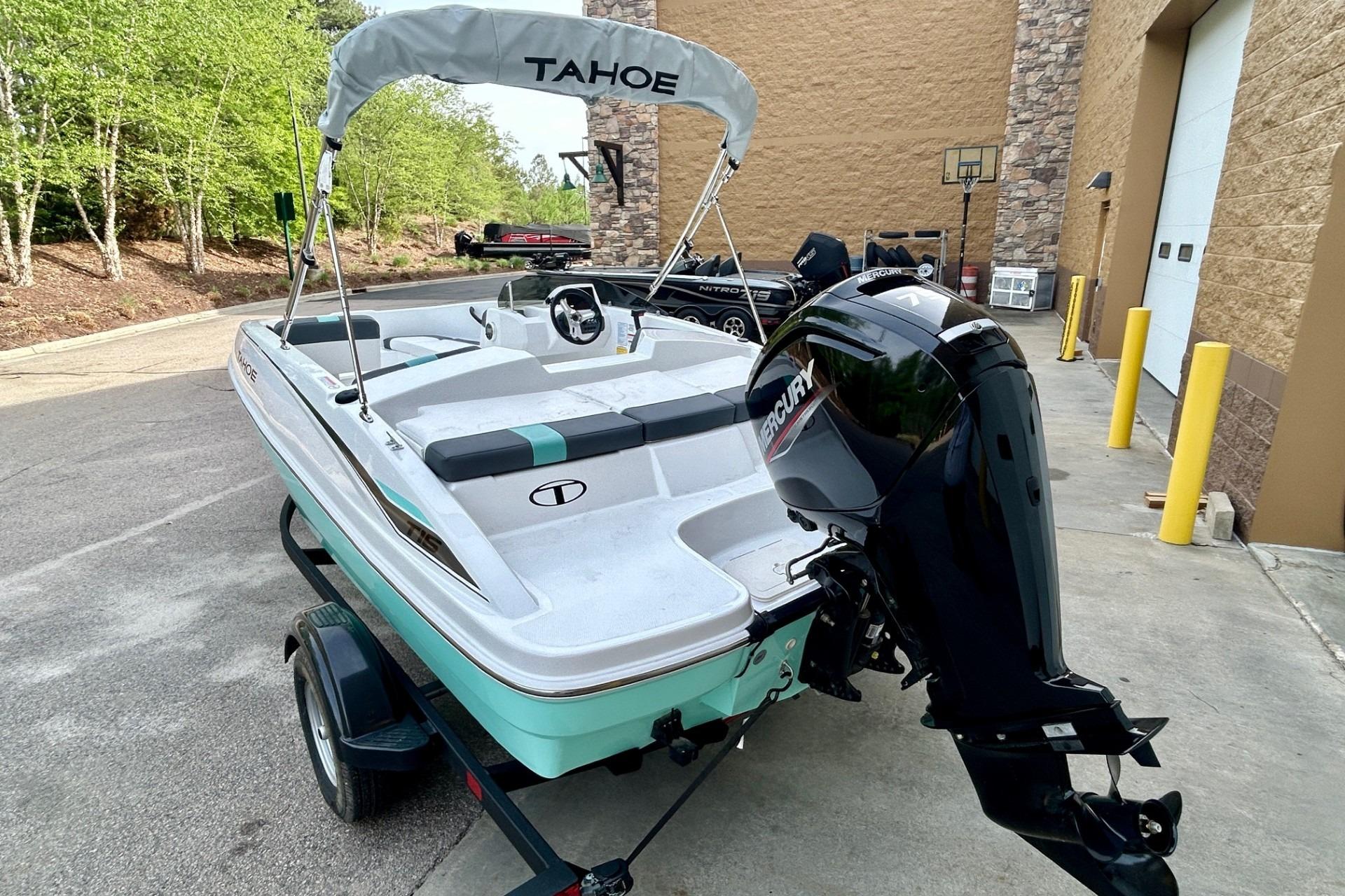 2026 Tahoe T16 boat with Mercury engine, parked outdoors on a trailer.