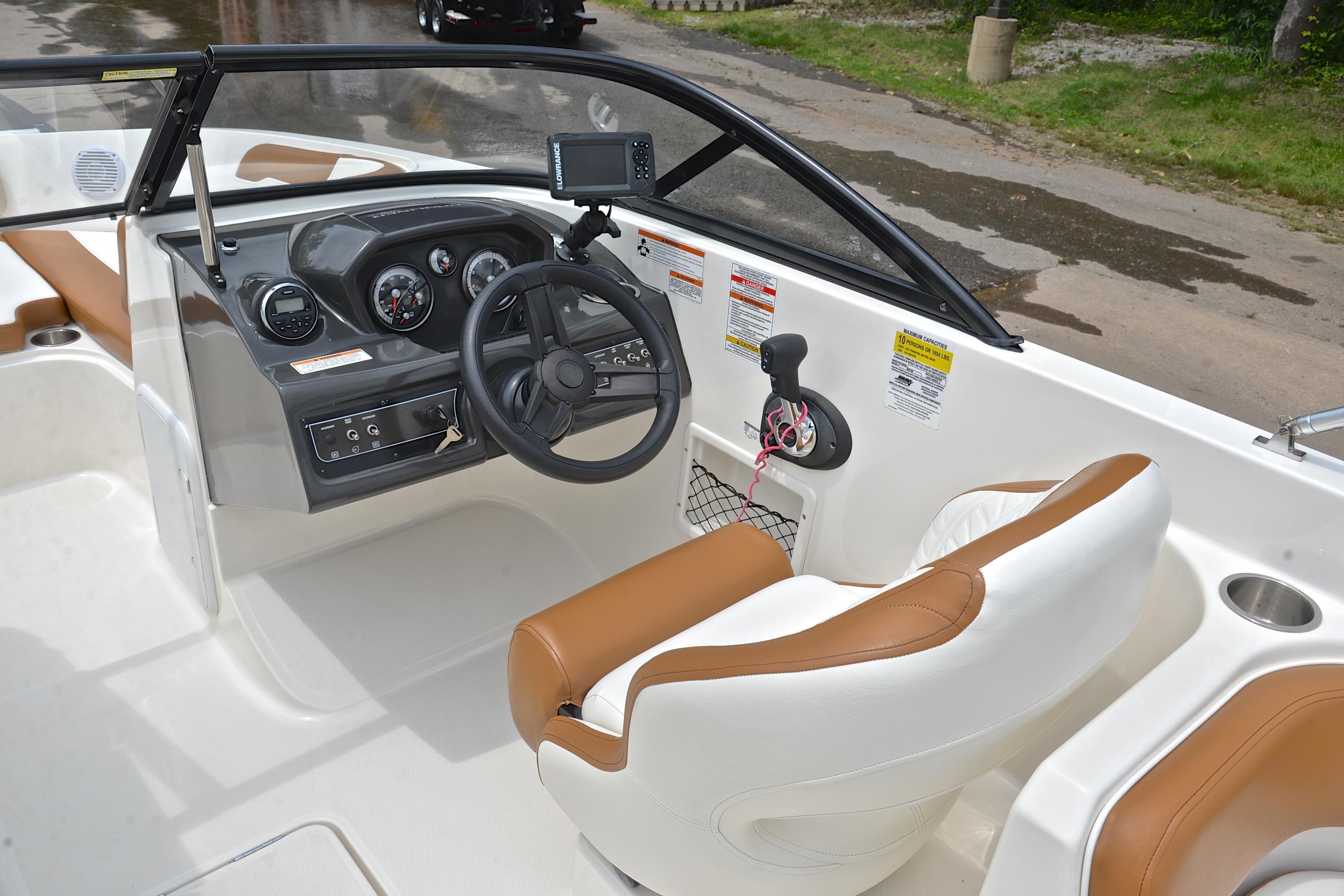2019 Bayliner VR6 Bowrider OB cockpit with steering wheel, gauges, and brown seating.