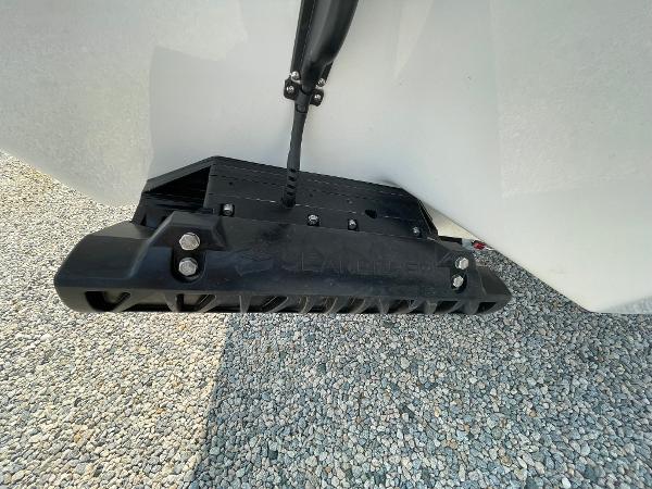2025 Tidewater 232 CC Adventure boat hull detail on gravel surface.