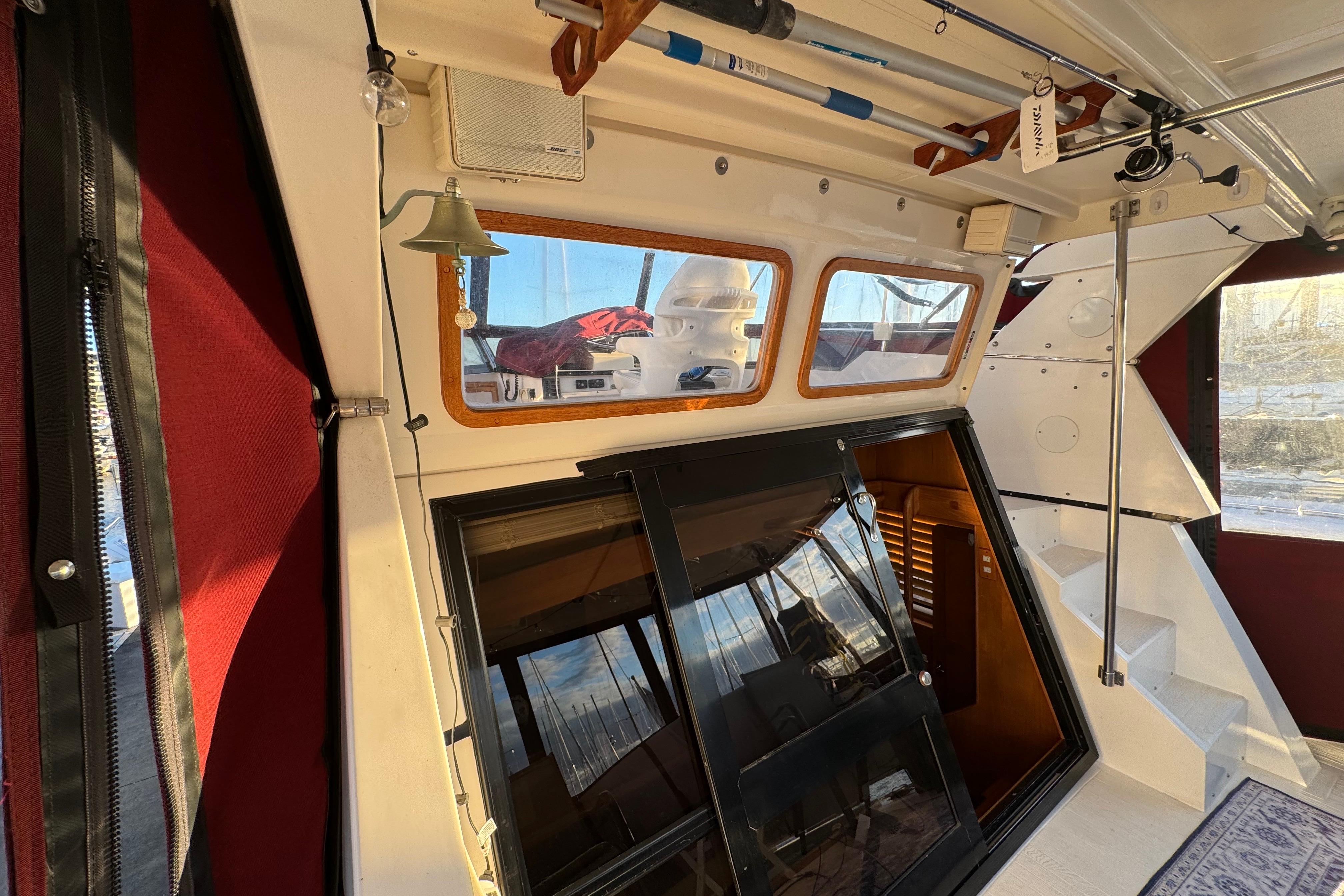 Interior of a 1987 President 37 boat with fishing rods and nautical decor.