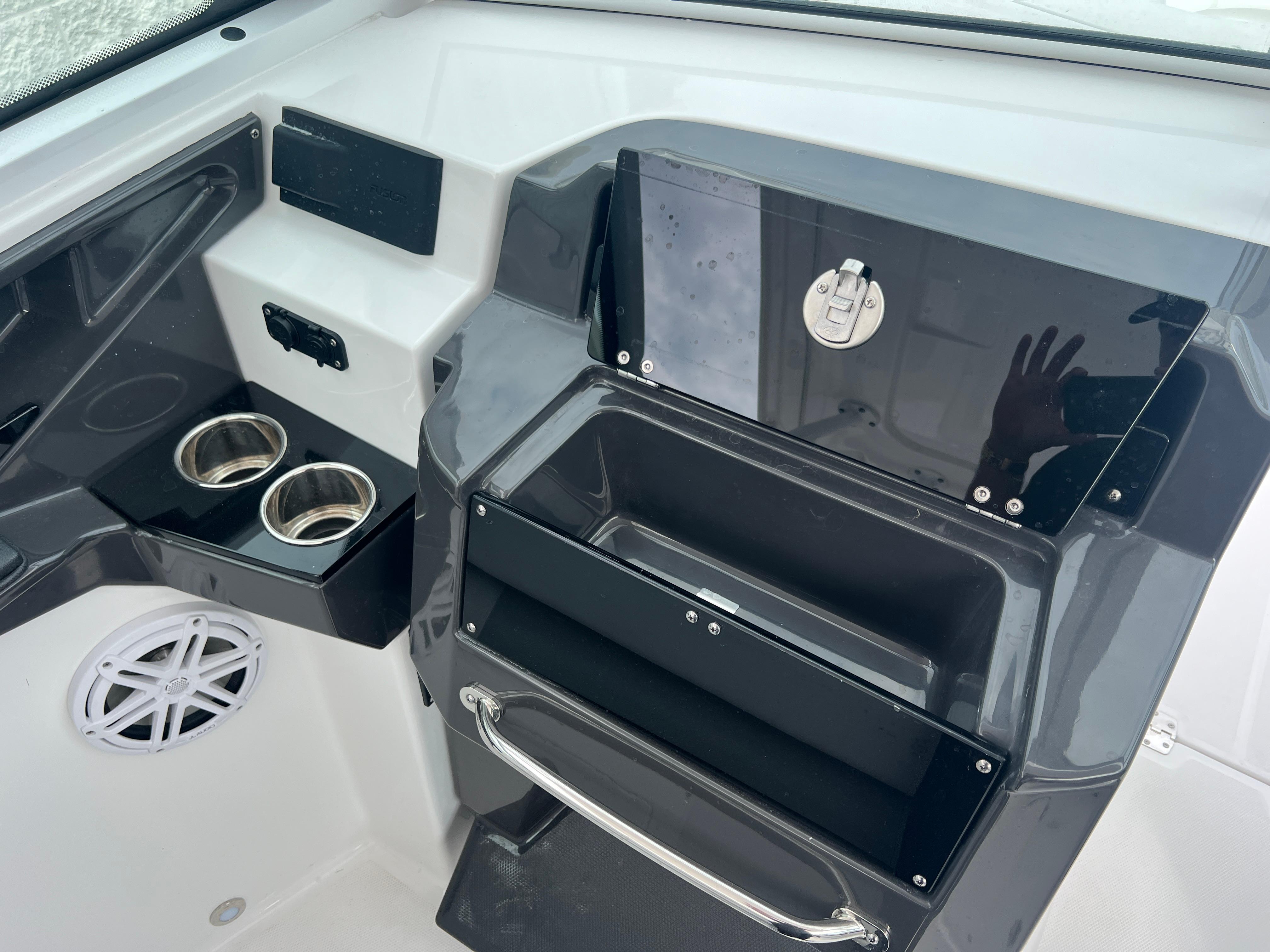 2024 Blackfin 272 DC boat interior with cup holders and storage compartments.