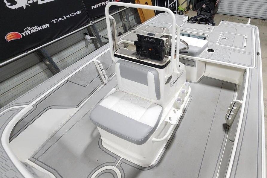 2026 Mako 18 Pro Skiff interior with seating and navigation equipment.