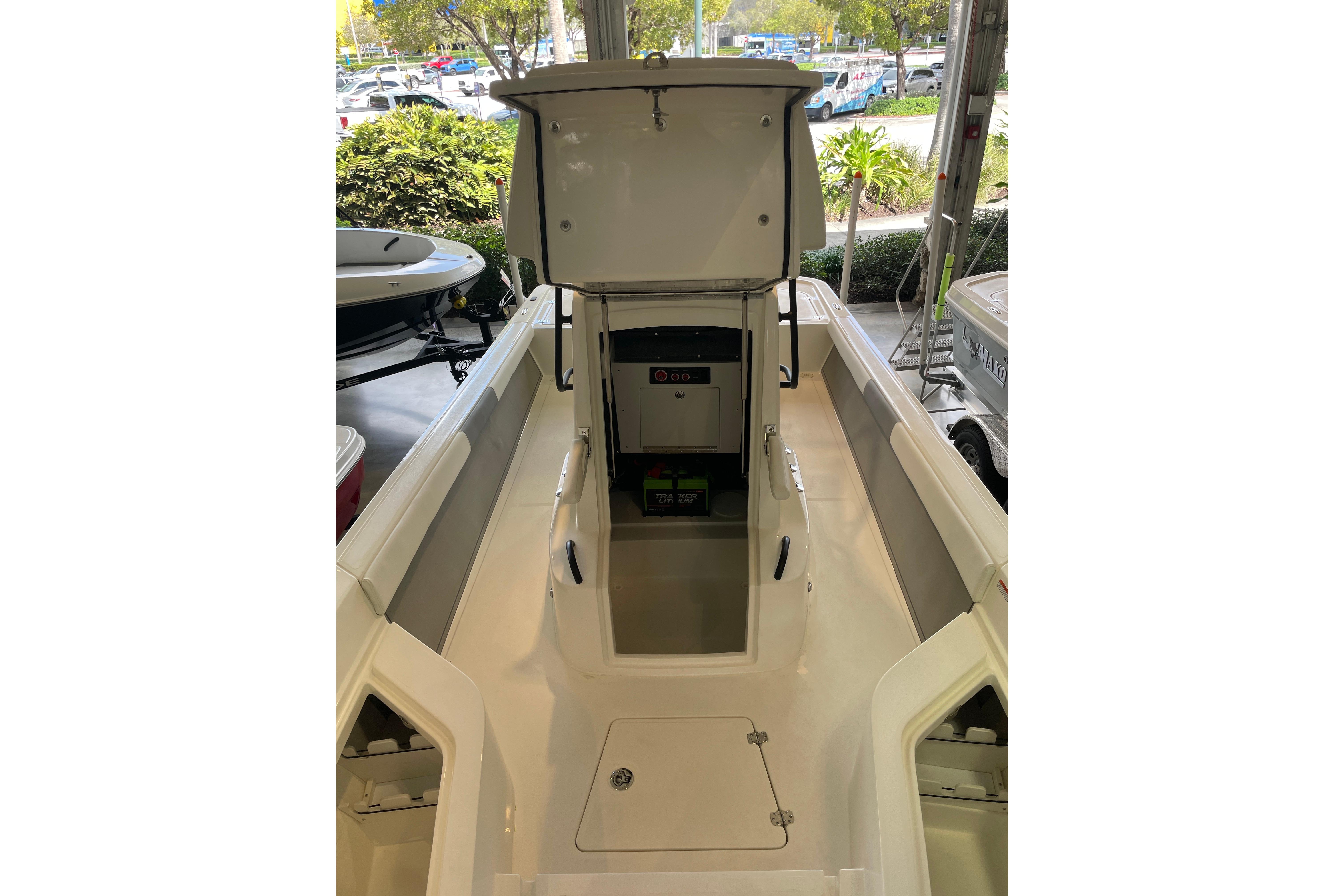 2026 Mako 24 APEX boat interior with open storage compartment, showcasing sleek design.
