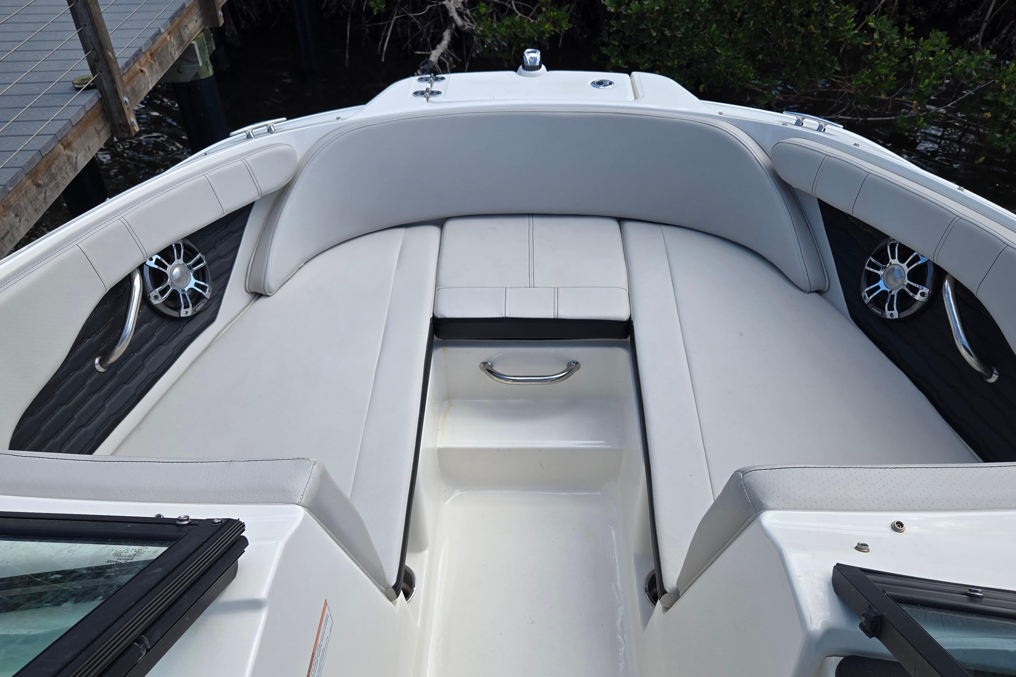 2023 Sea Ray SPX 210 boat interior with white seating and speakers.