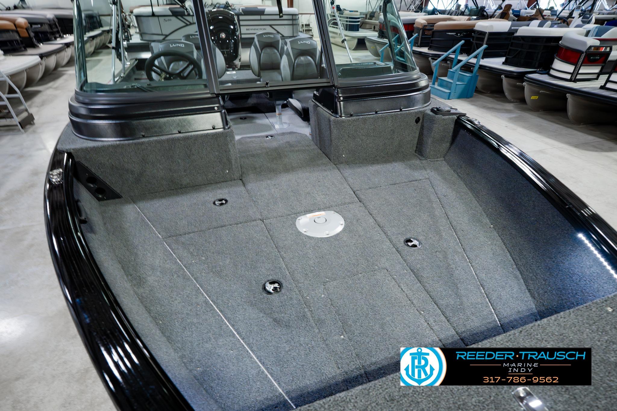 2026 Lund 1875 Impact XS boat interior with carpeted deck, showcased at Reeder-Trausch Marine.