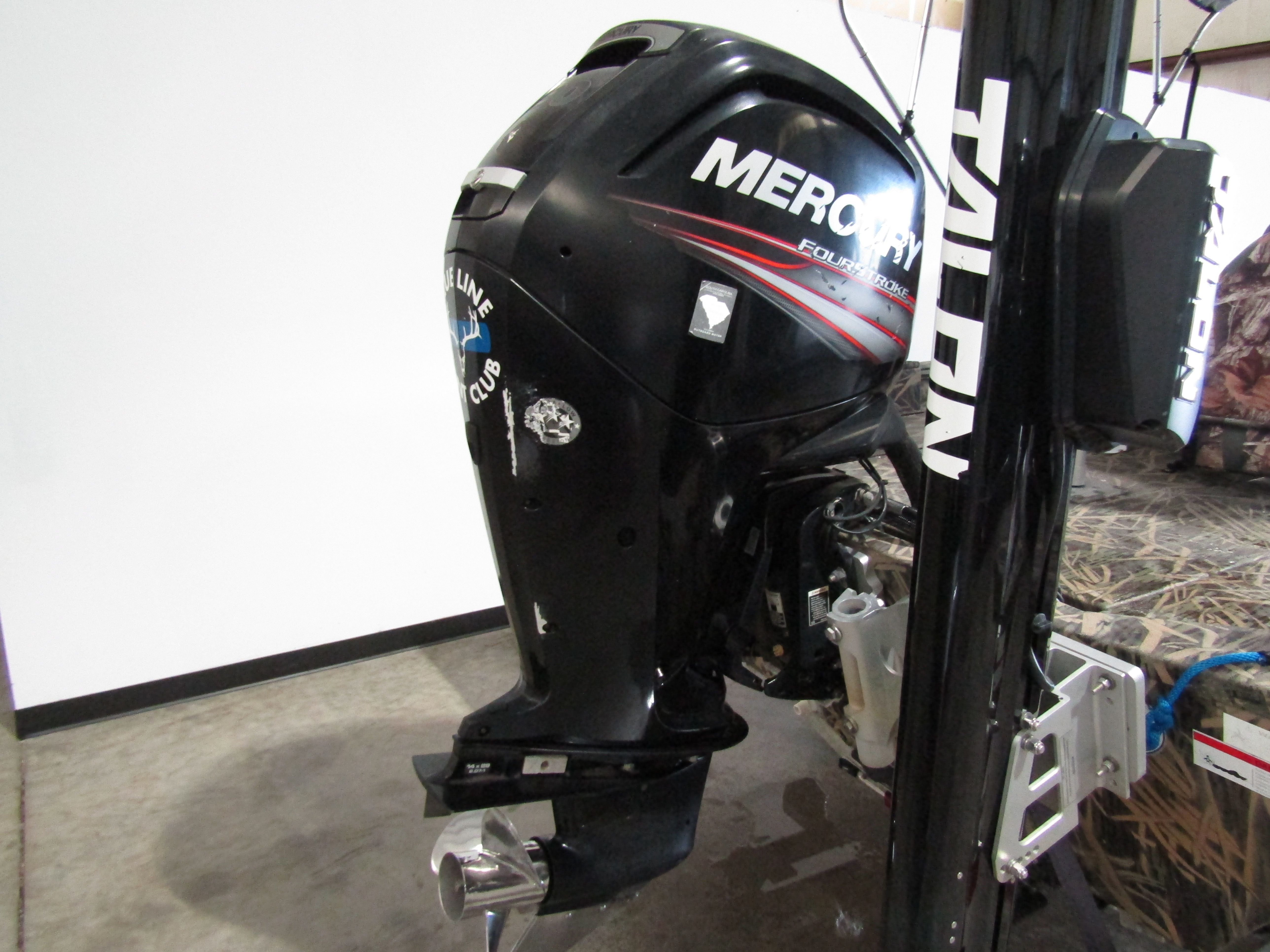 A Mercury outboard motor on a boat, next to a Talon anchor system.