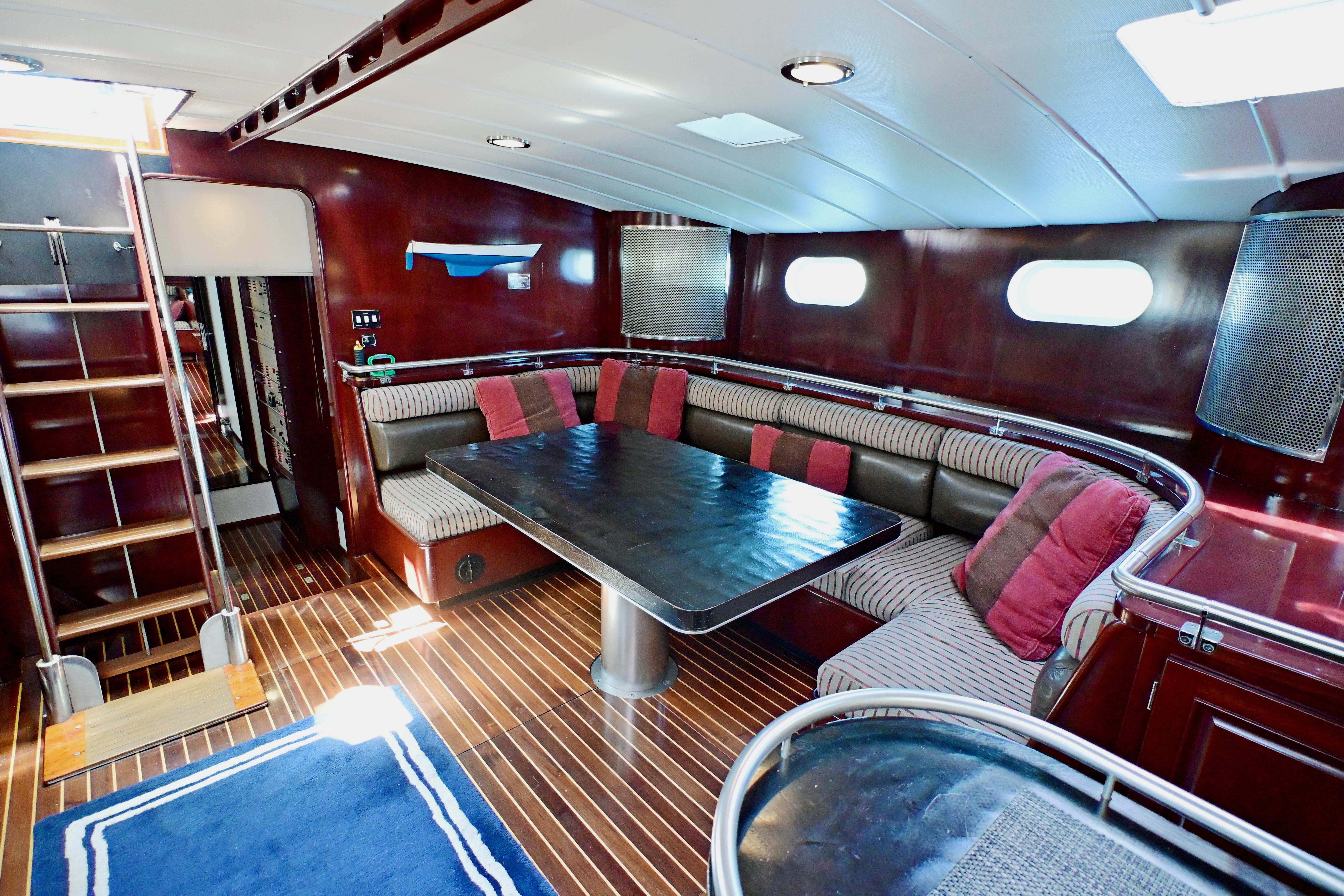 Luxurious interior of 1968 Abeking & Rasmussen Tripp 74 yacht with elegant seating and wooden finishes.