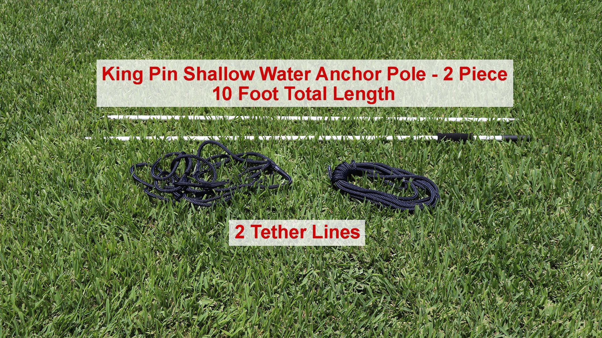 Two anchor poles and two tether lines are laid out on the grass.