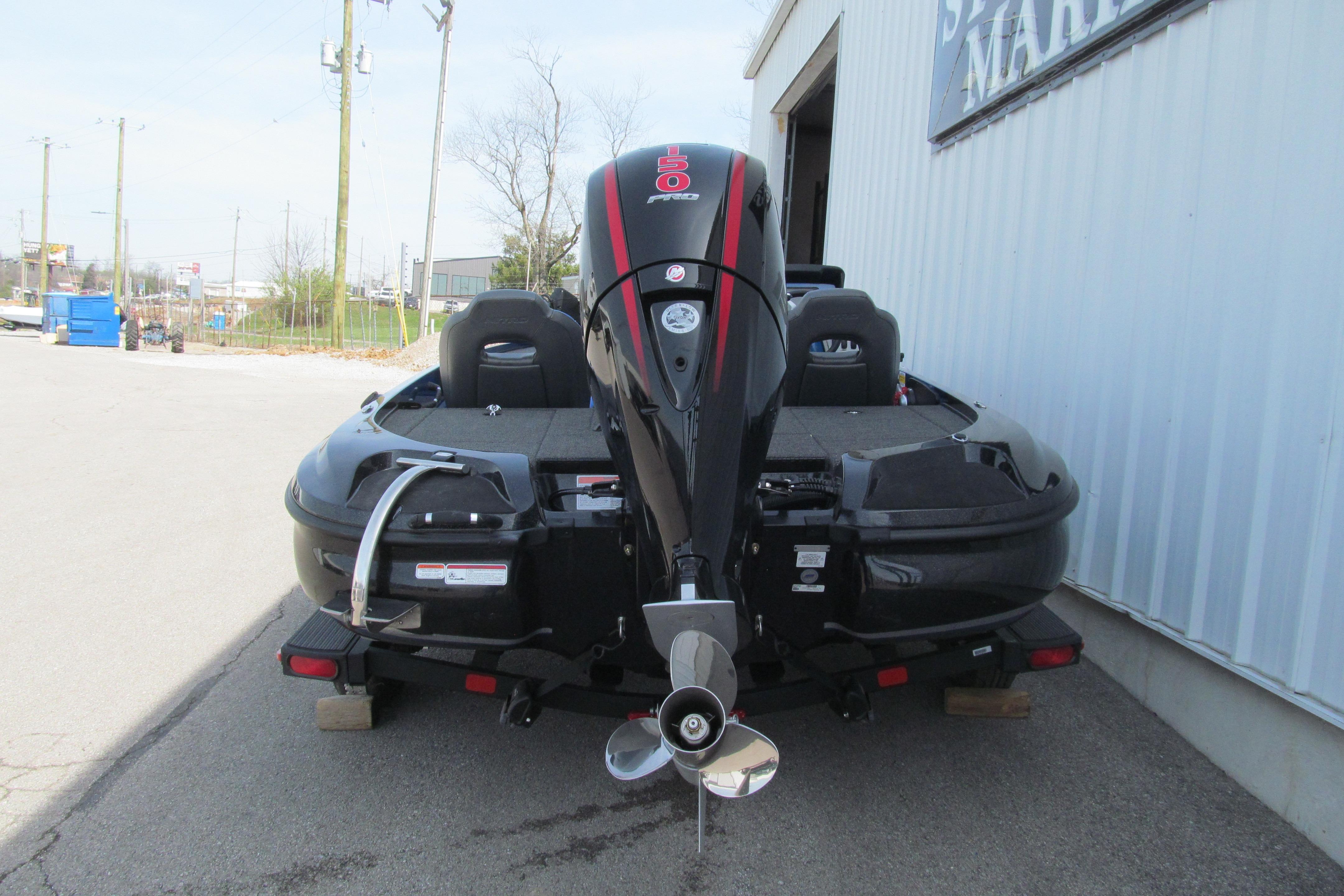 2026 Nitro Z18 Pro boat with powerful outboard motor, parked outside a marine shop.