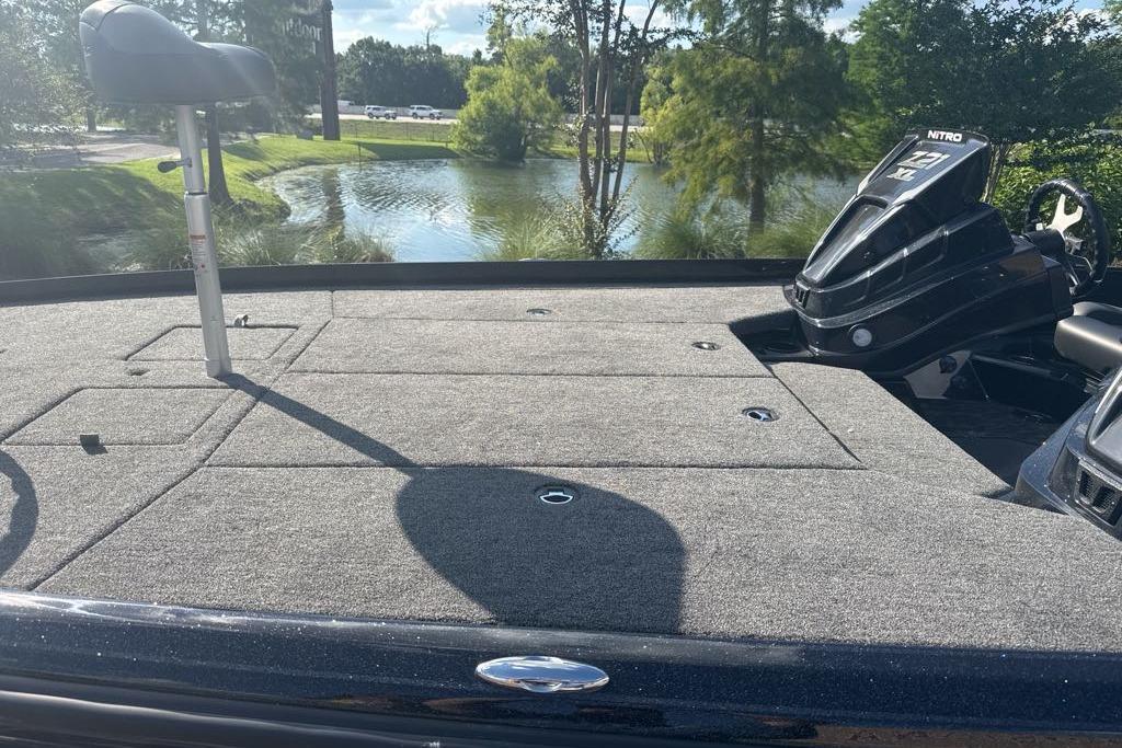 2026 Nitro Z21 XL boat deck with seating, overlooking a serene pond.