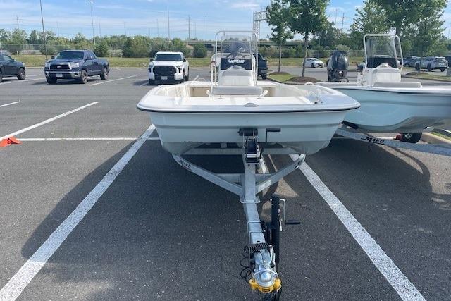 2026 Mako Pro Skiff 17 CC boat on trailer in parking lot.