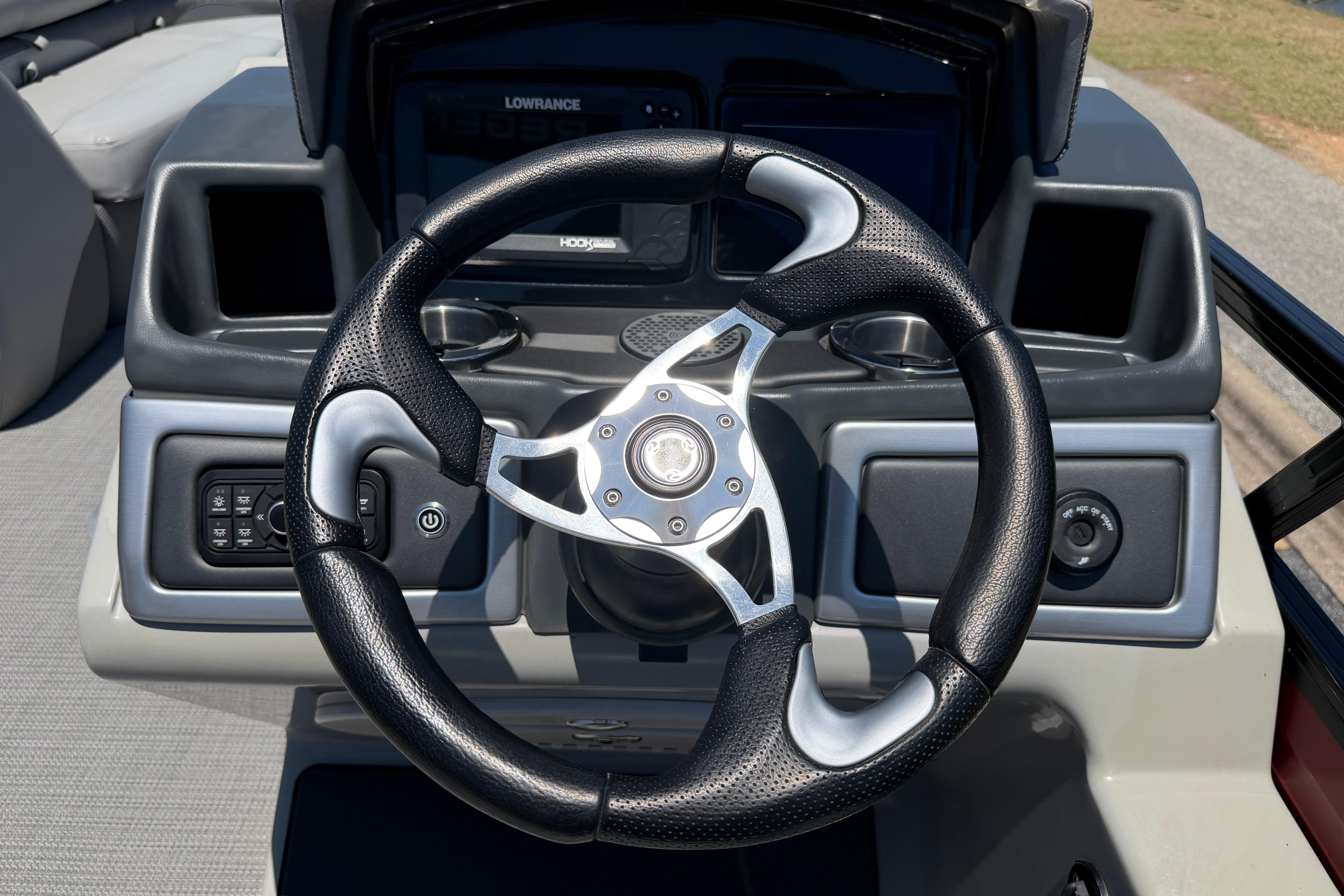 Steering wheel of 2024 Regency R250DL3 boat with modern dashboard controls.