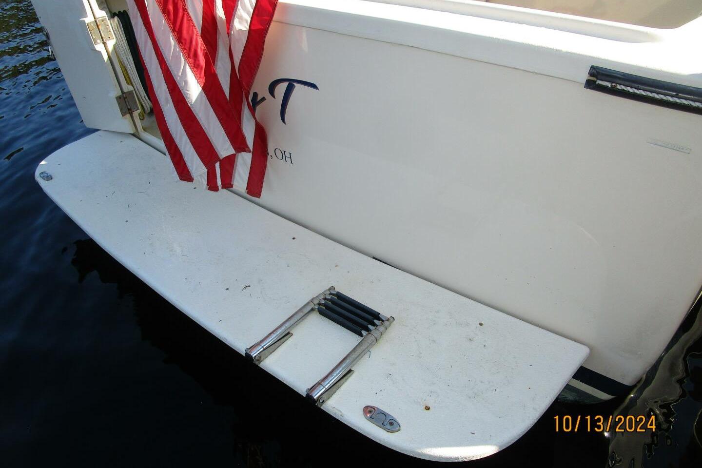 1997 Rosborough Trawler with American flag and swim platform ladder.