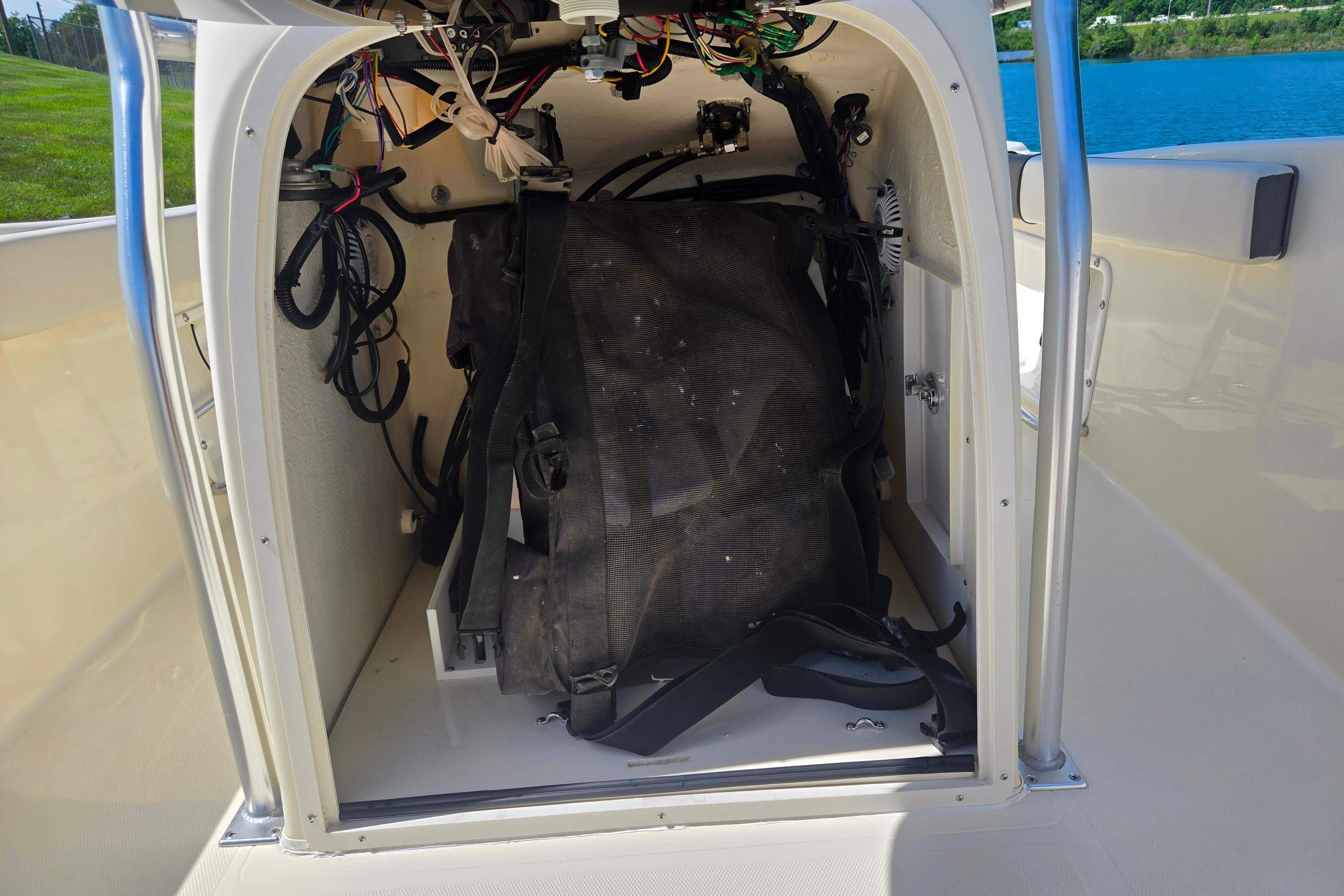 Key Largo 2000CC 2016 boat interior wiring and storage compartment by the water.