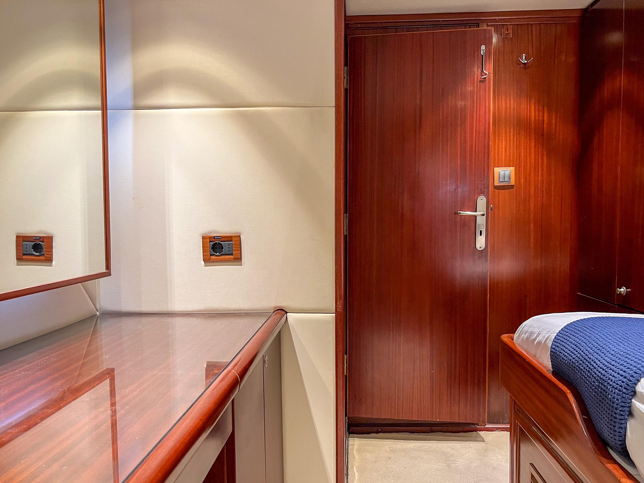 Luxurious wooden interior of a 1969 Psarros Shipyard custom yacht cabin.