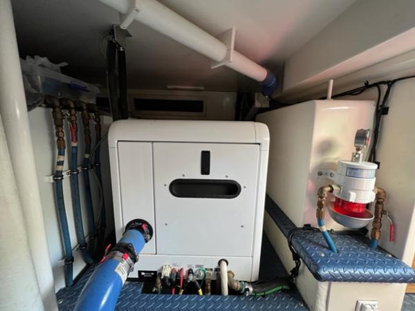 Engine room of a 2009 Ovation 52 yacht with plumbing and electrical systems.