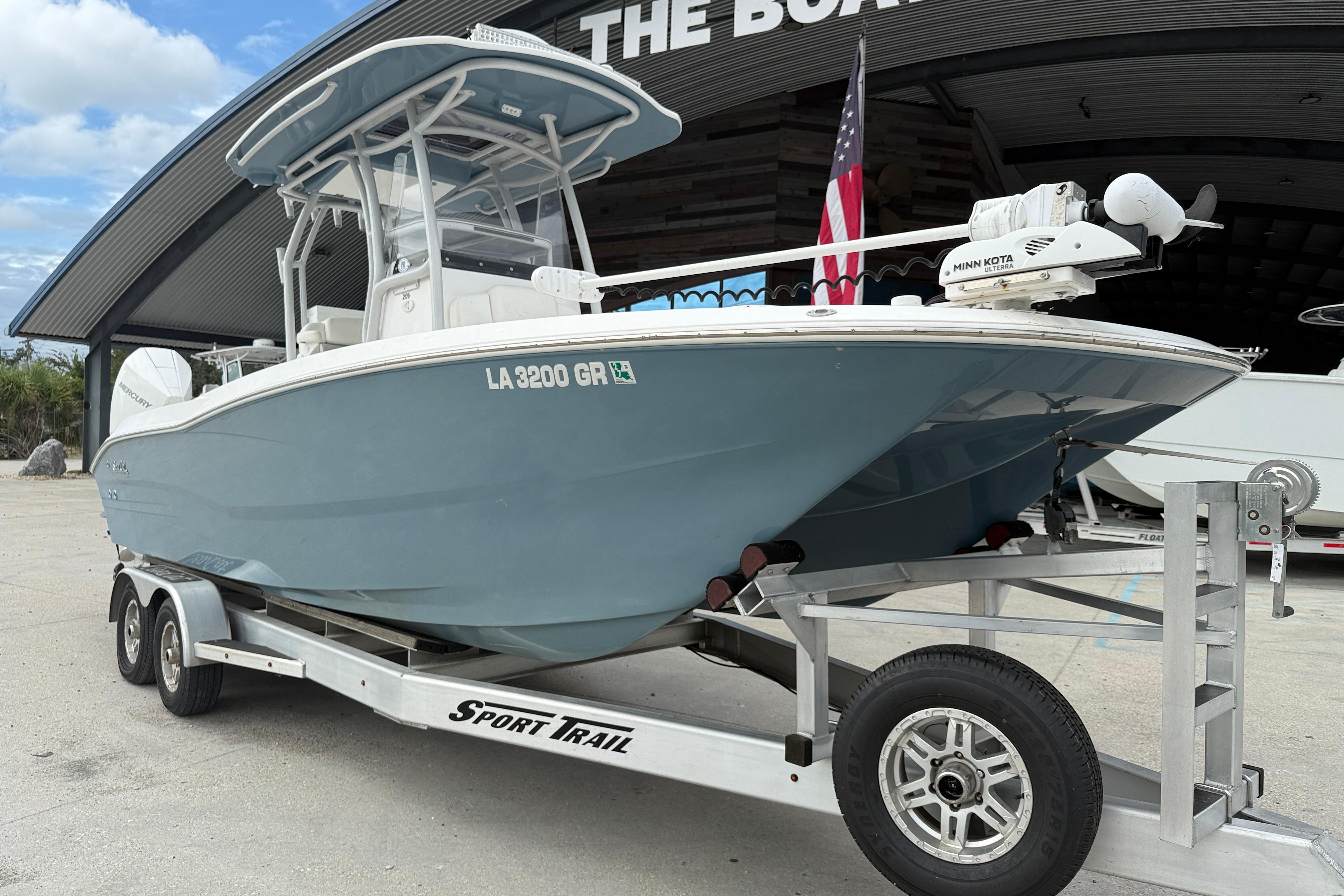 2021 Sea Cat 260 boat on trailer, displayed outdoors with American flag.