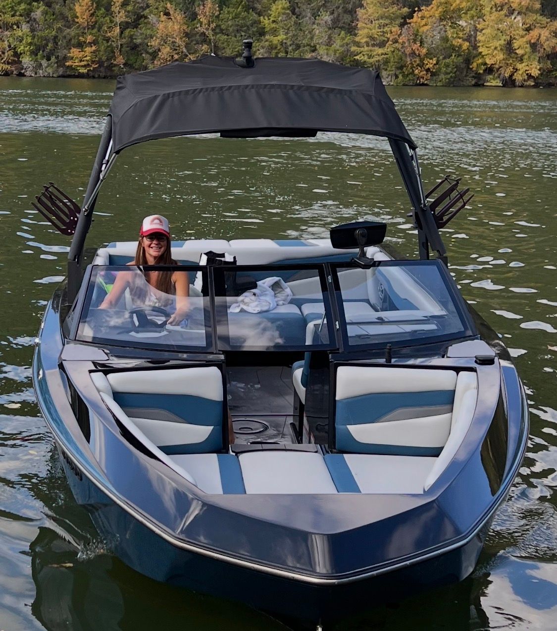 Woman driving 2022 Axis T220 boat on a lake.