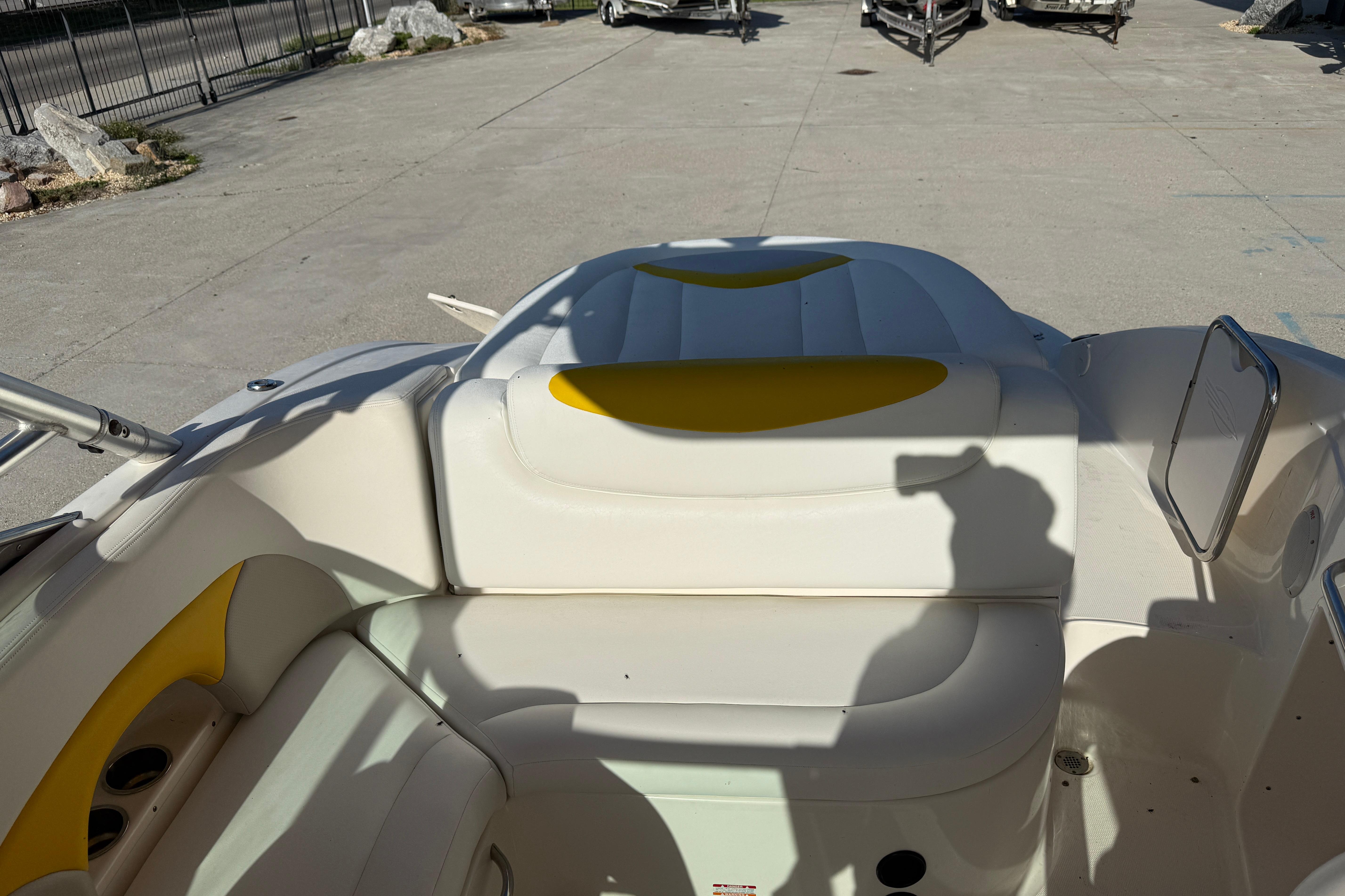 2008 Chaparral 236 SSX boat interior with white and yellow seating.