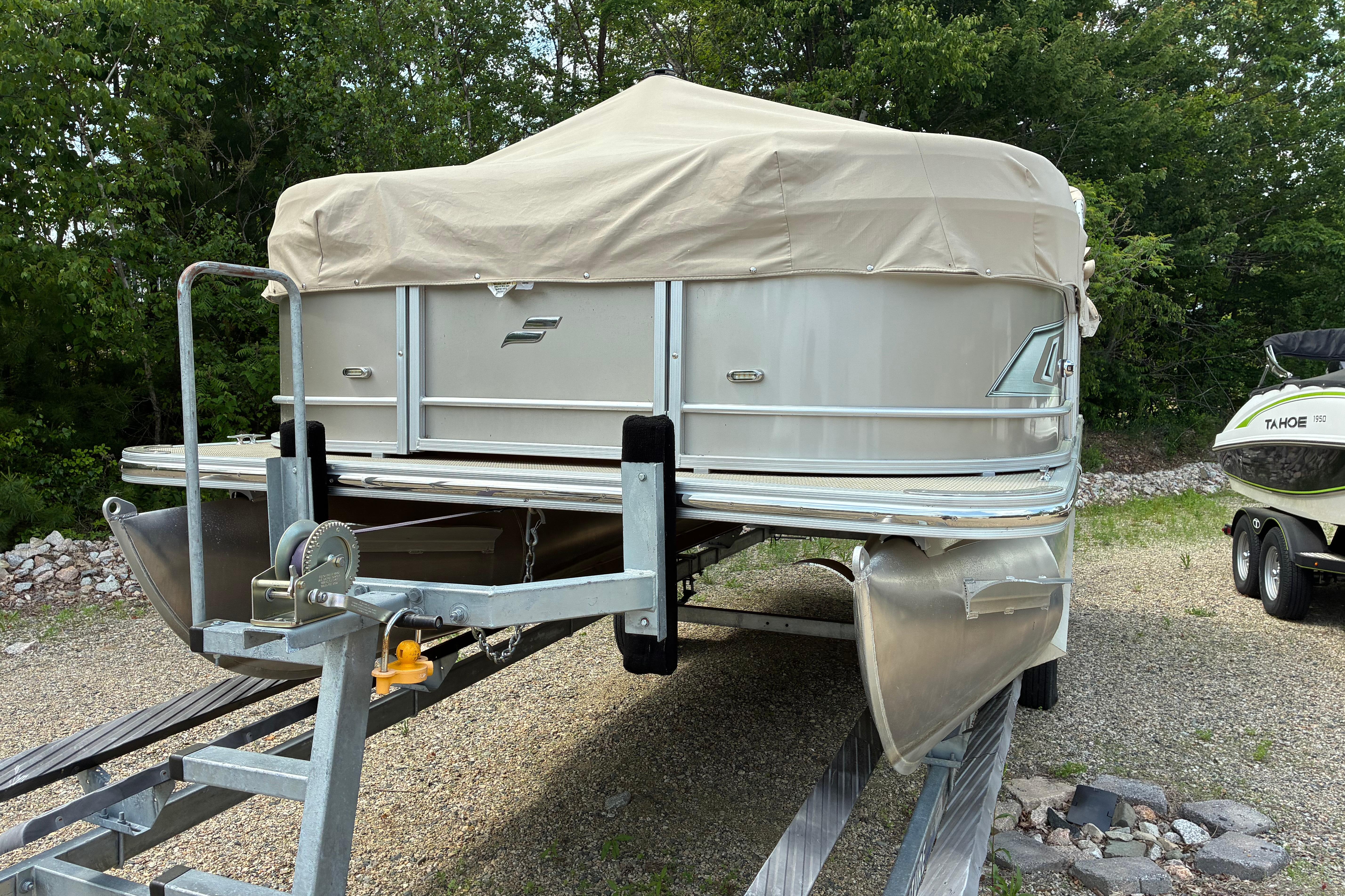 2020 Starcraft EX 20 C pontoon boat on trailer, covered, in outdoor setting.