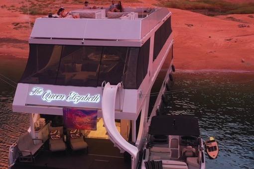 Luxury yacht "The Queen Elizabeth" by Adonia, 2021, docked at sunset with rooftop lounge.