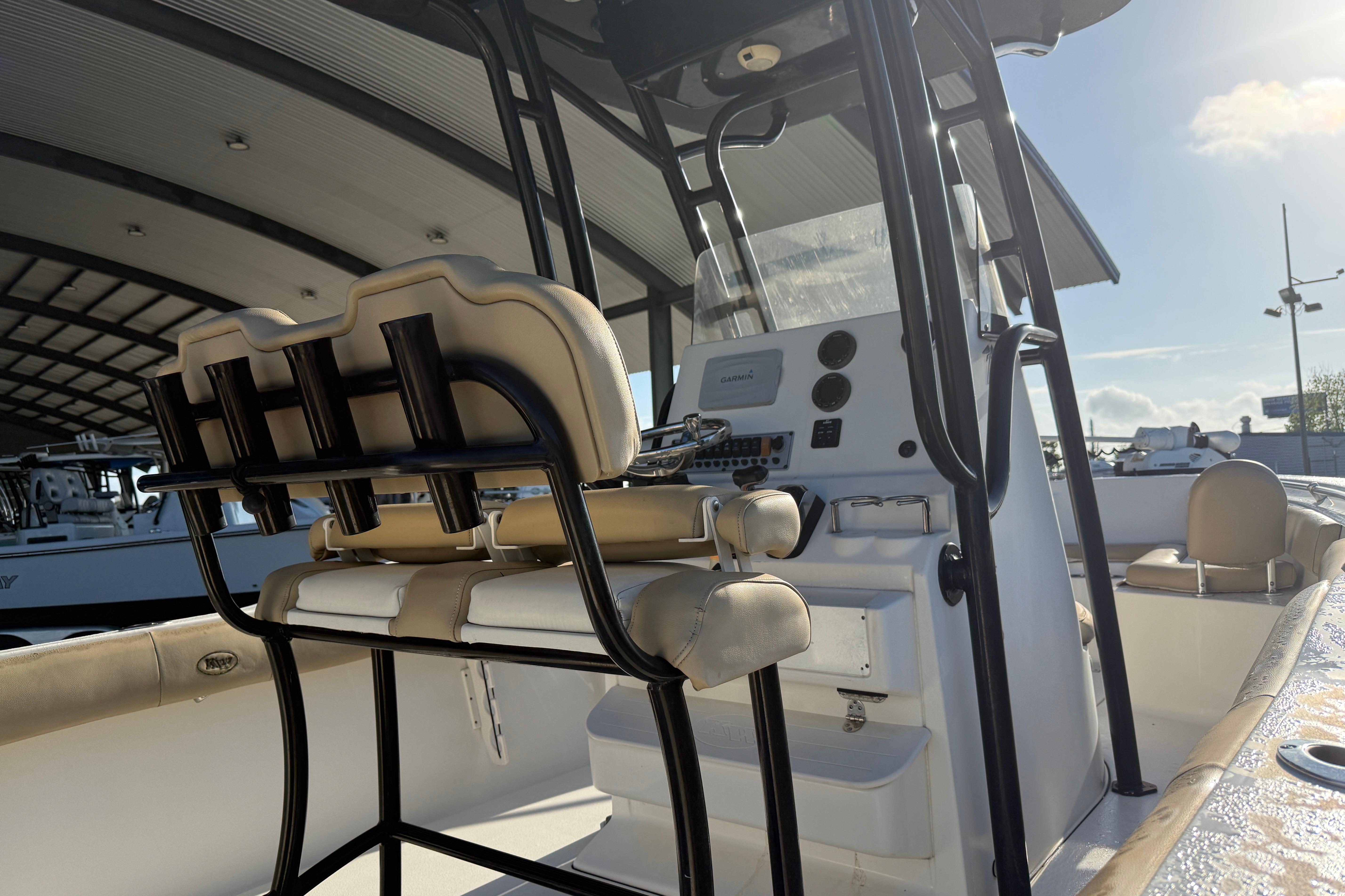 2016 Key West 239 FS boat interior with helm and seating under a canopy.