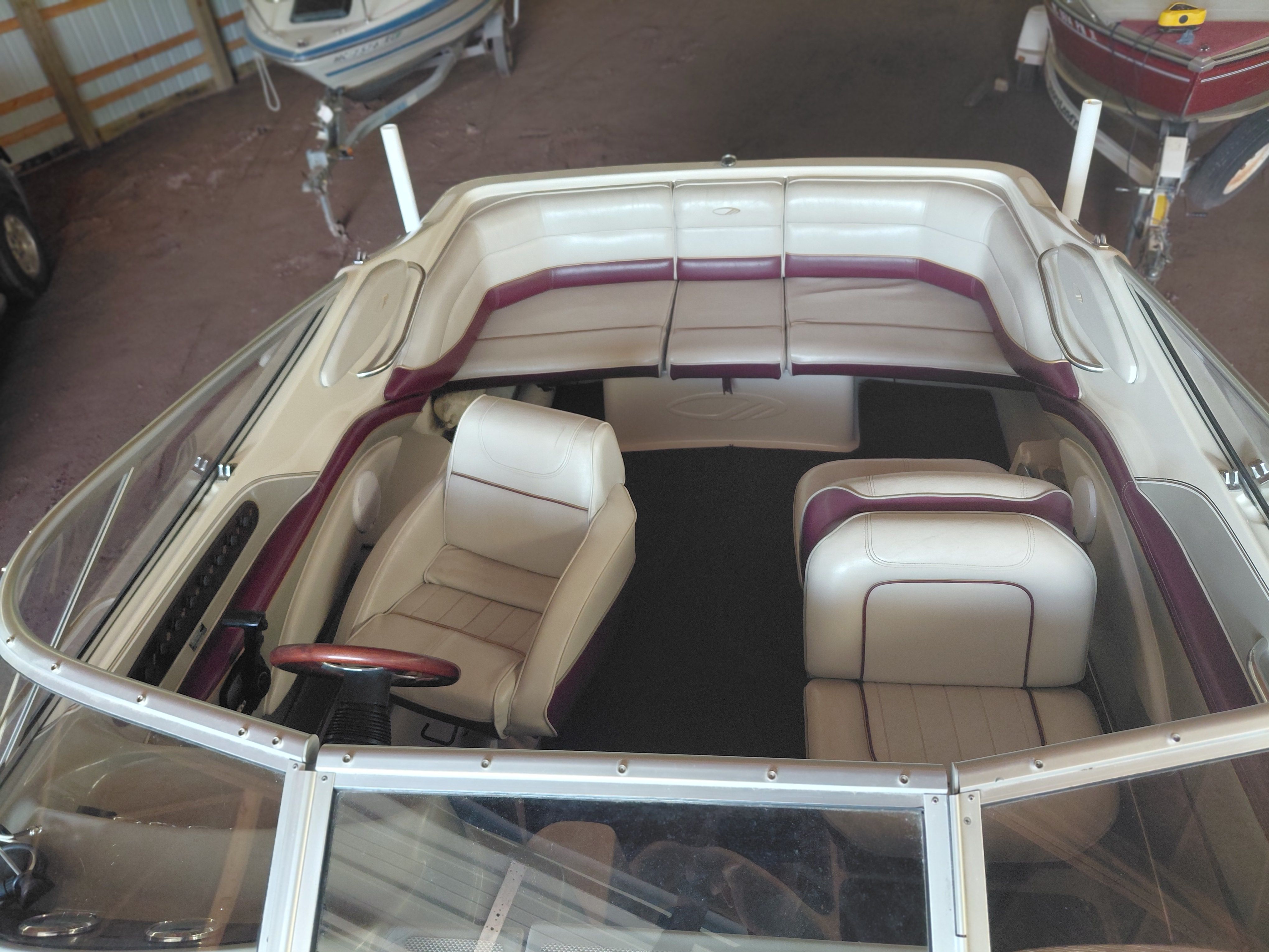 Interior view of a 1997 Maxum 2300 SC with white and maroon seating.